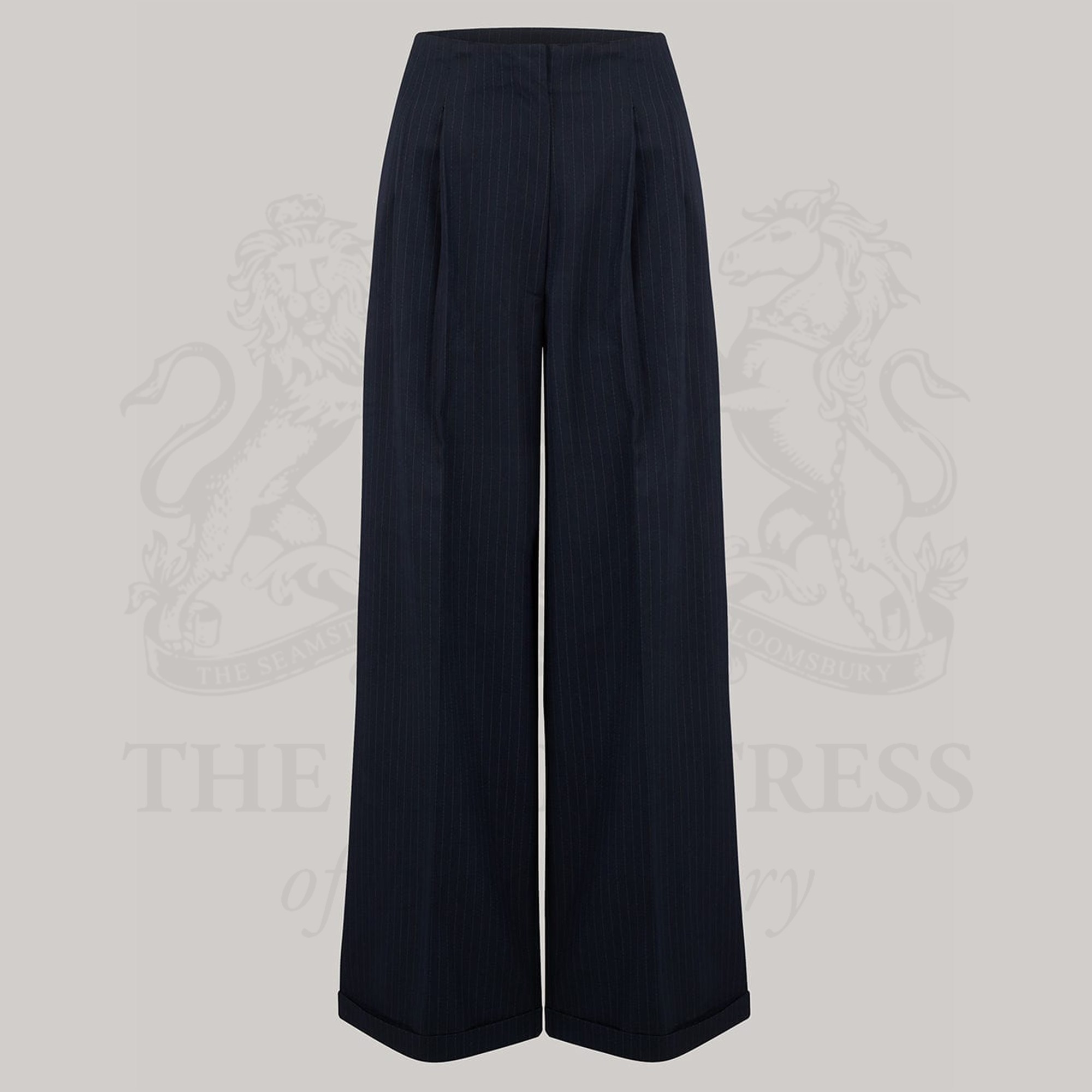 High-waisted tailored navy pinstripe trousers on a grey background.