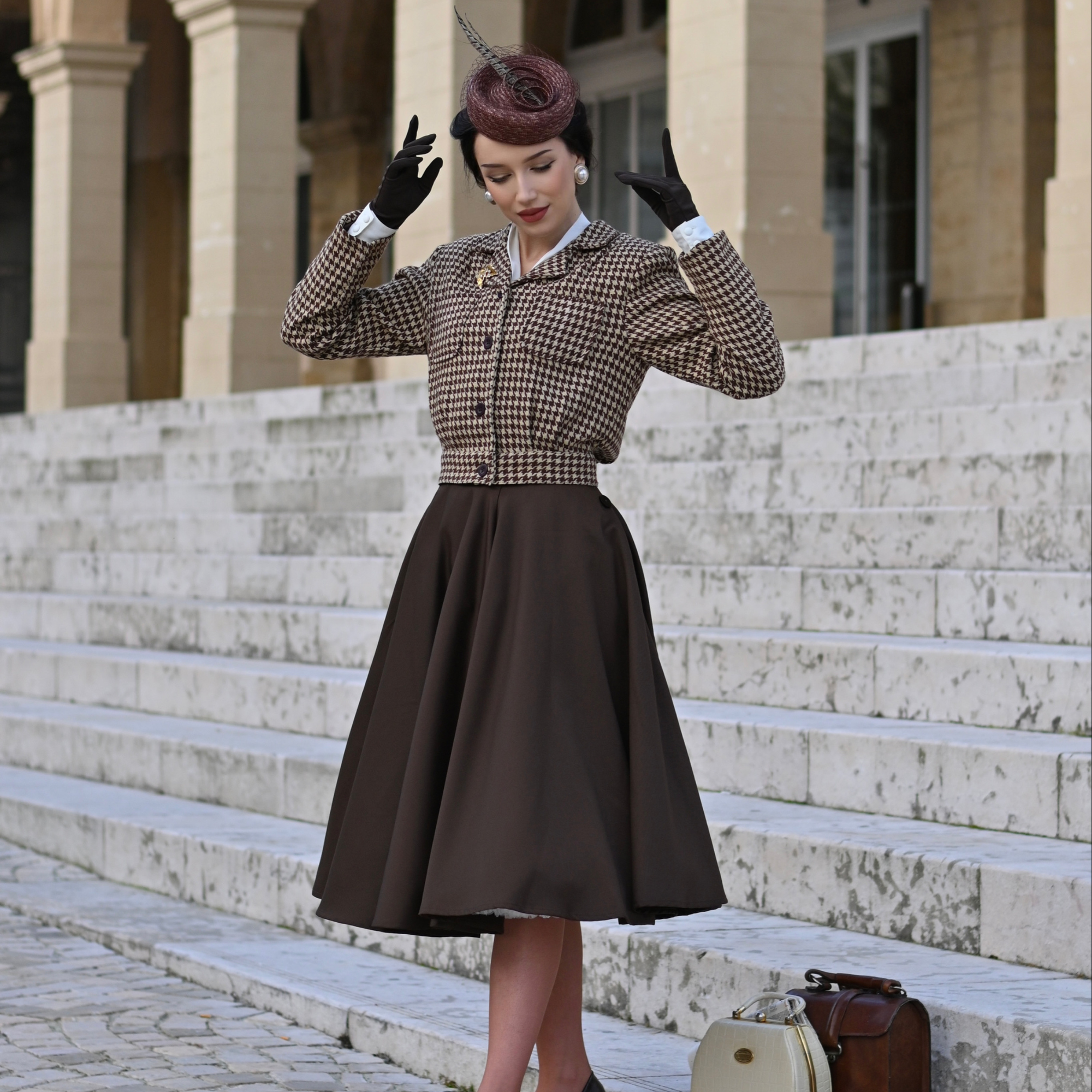 Woman in vintage outfit standing on stone steps outdoors