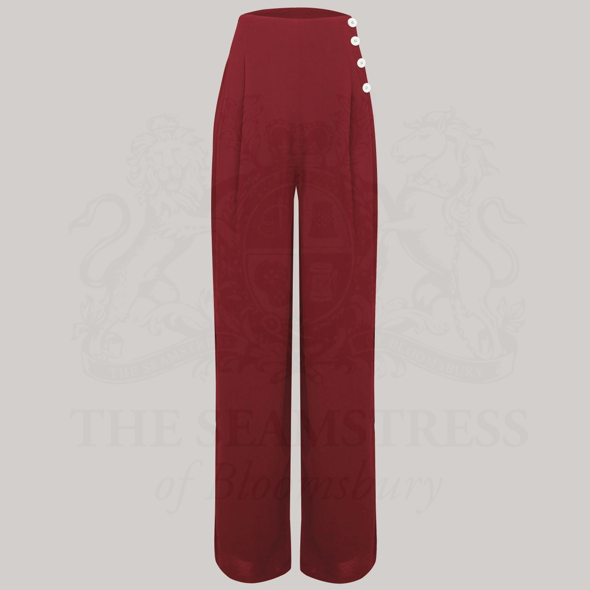 Wide-leg 1940s women’s trousers in burgundy. Four decorative buttons are down the left from the waist with a hidden zip in the side seam. 