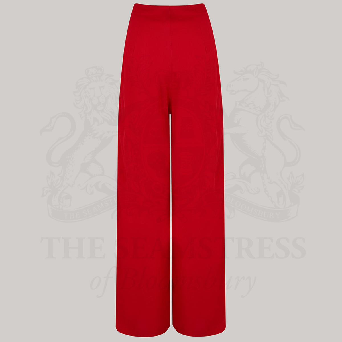 Wide-leg 1940s women’s trousers in red. Four decorative buttons are down the left from the waist with a hidden zip in the side seam. 