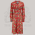 A 1940s style long sleeve dress in red atomic inspired print. Featuring gauged-in top yoke detailing on the shoulders and sleeves that puff out fully at the cuff. 4 small buttons down the front of the dress, and a tie-waist belt. 