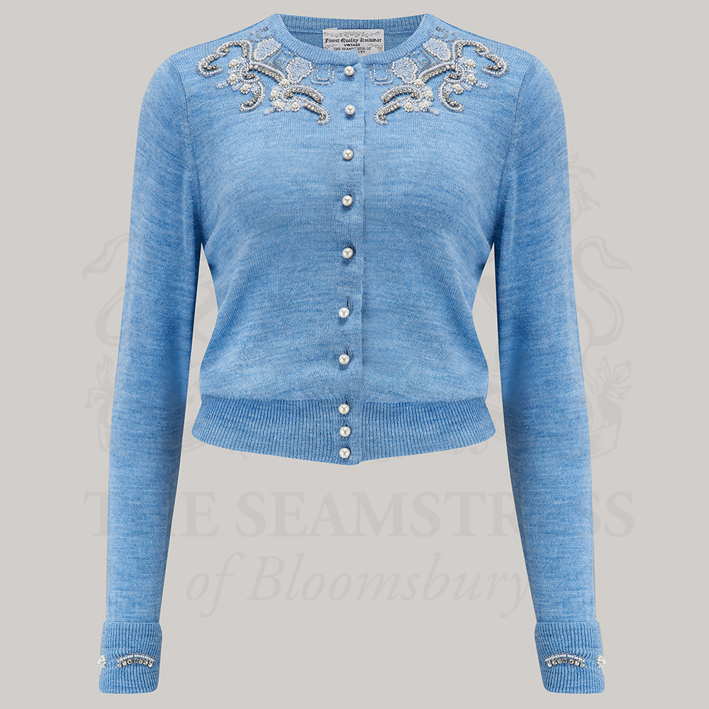 A blue marl cardigan with hand beading detail, pearlescent buttons, and ribbing at the waist.