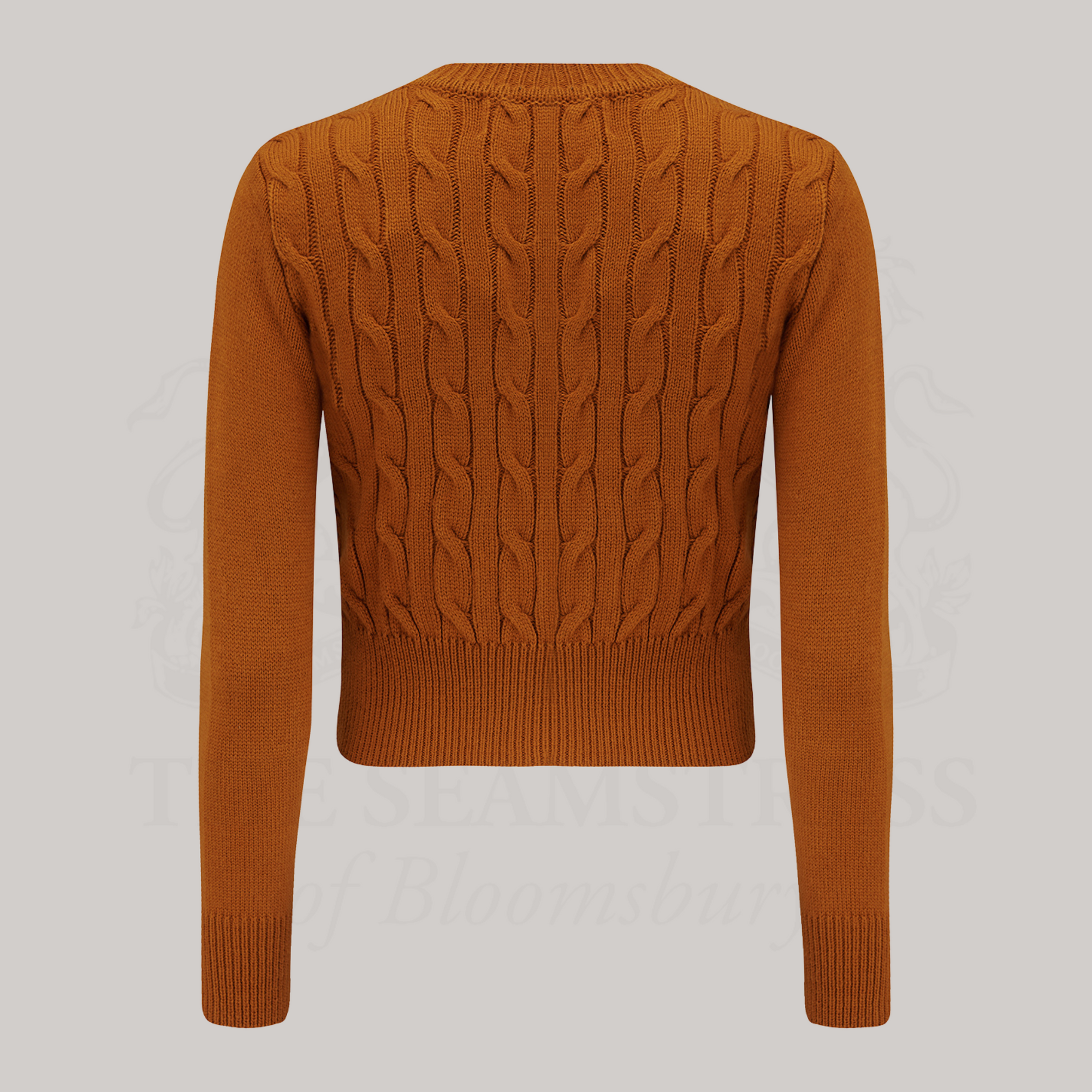 A 1940s style cable knitted cardigan in ginger. 
