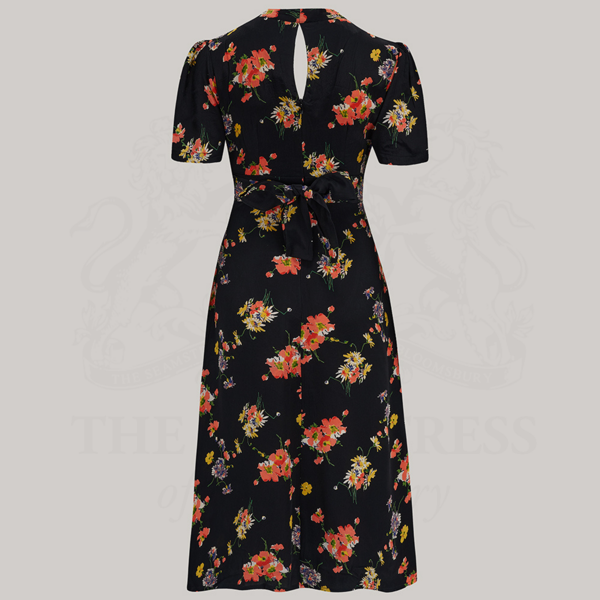 a 1940s-style black swing dance dress in black with yellow and pink floral pattern.