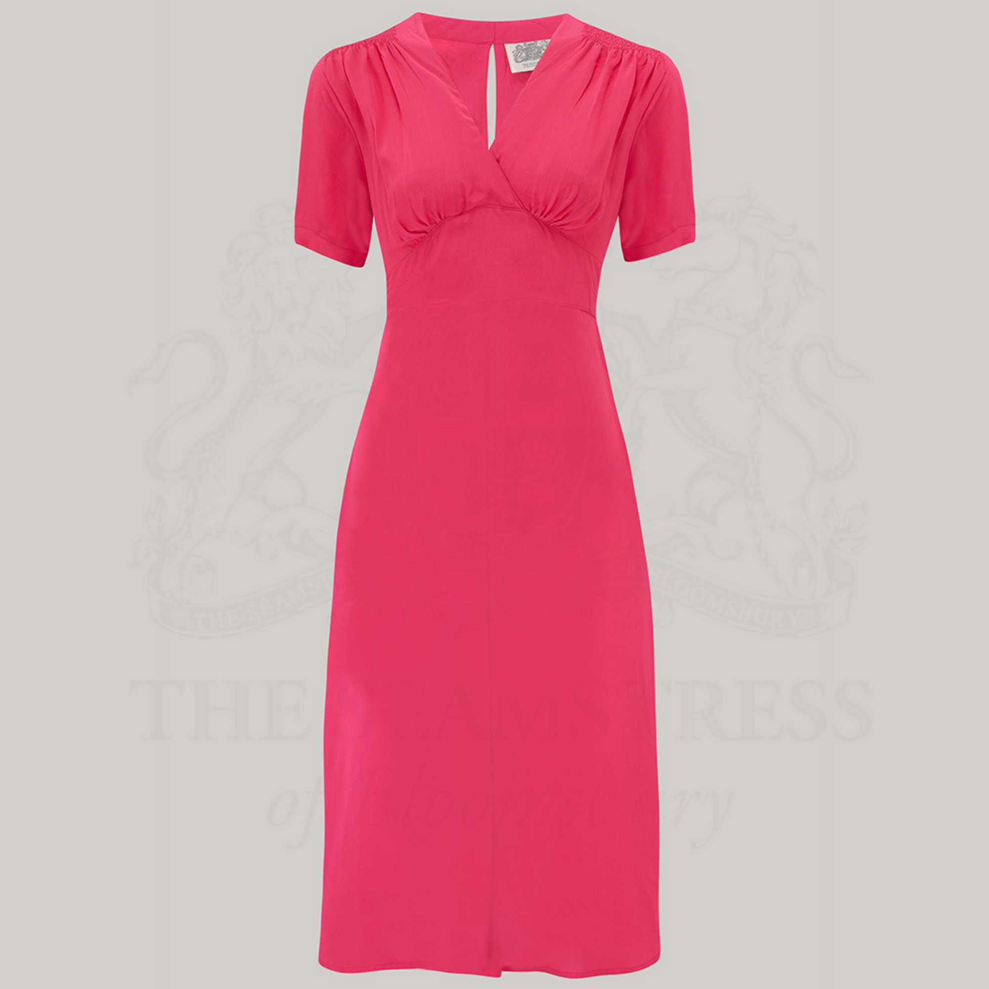 a 1940s-style swing dance dress in raspberry pink, with short sleeves