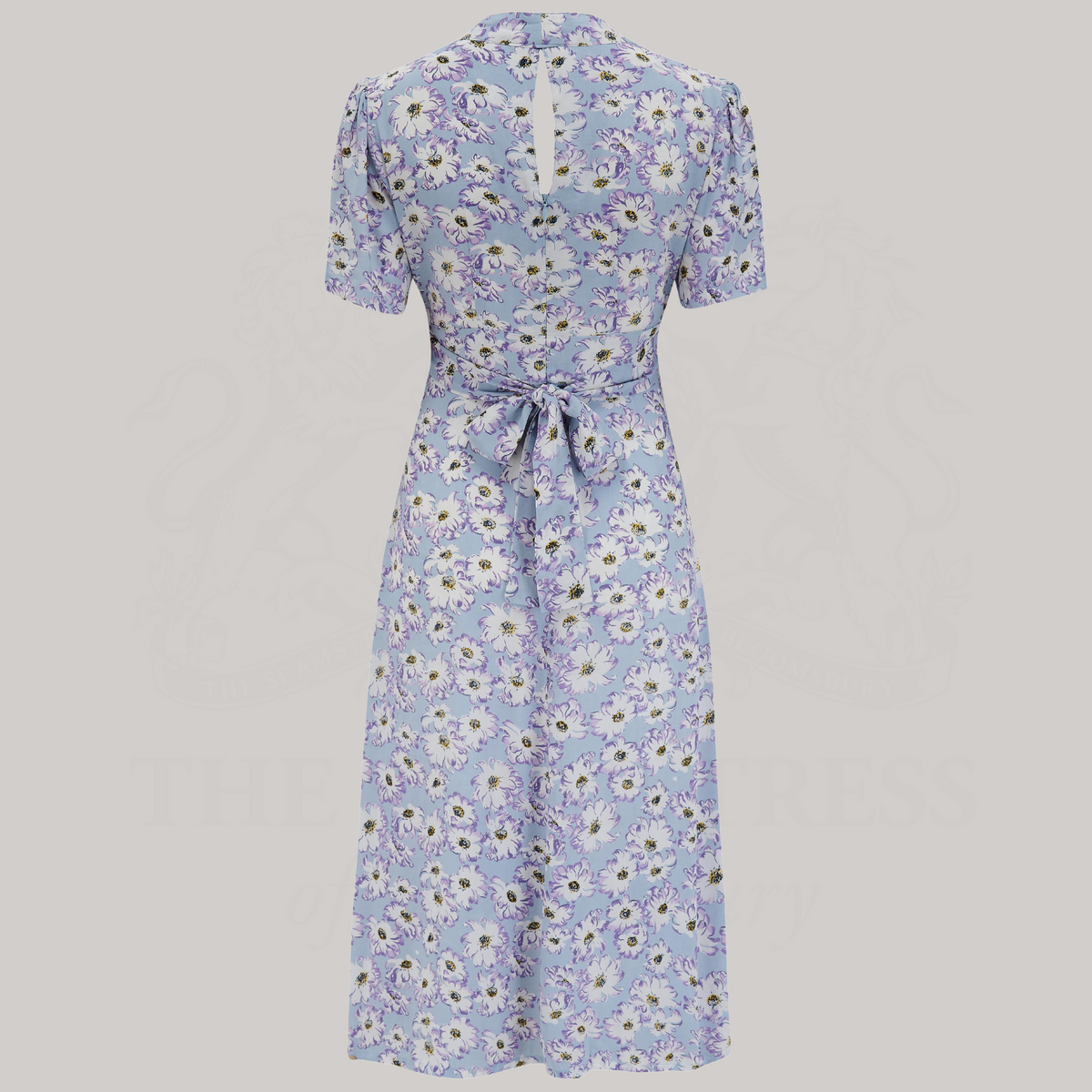 a 1940s-style dance dress in pale blue with a cream floral design and tie-waist belt at the back