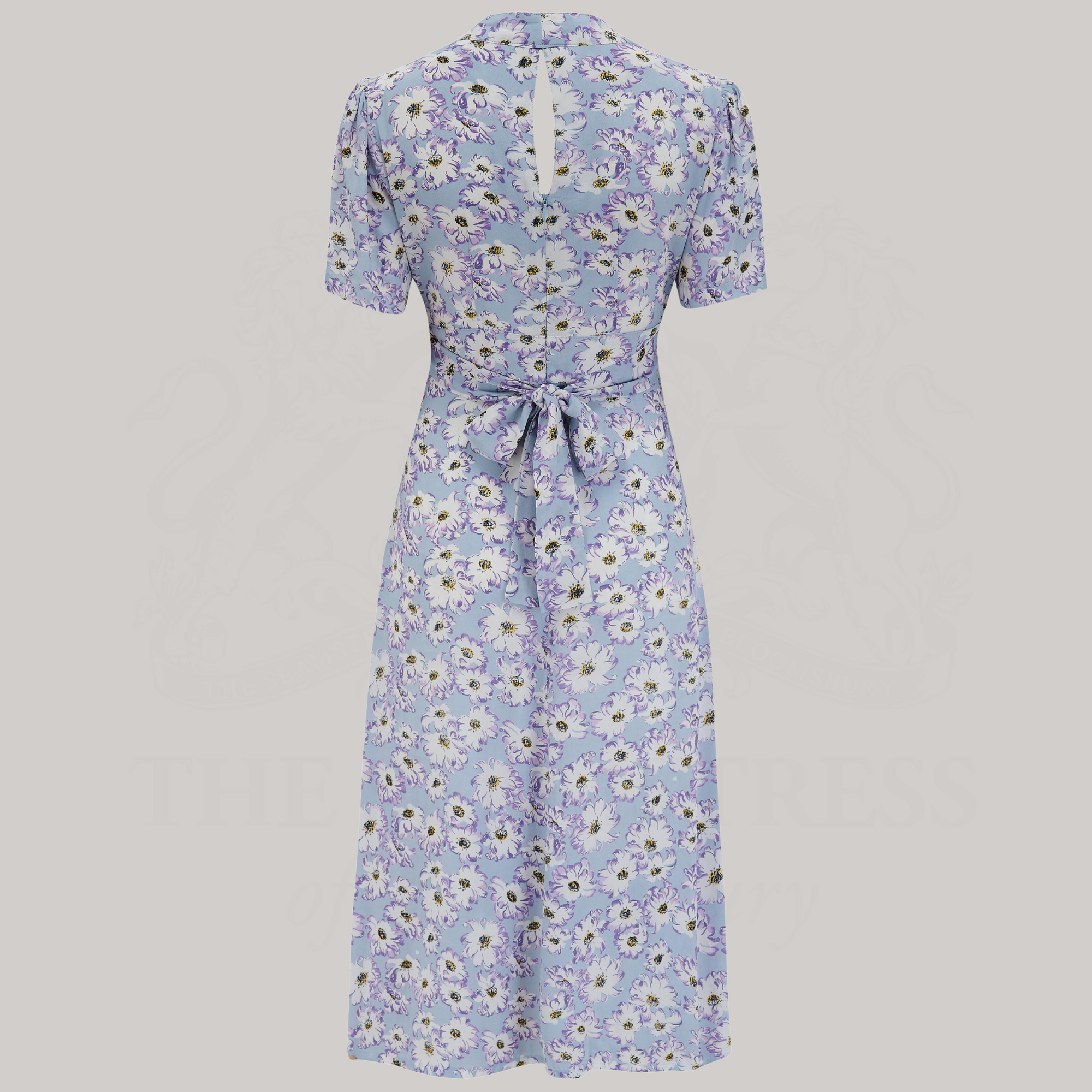 a 1940s-style dance dress in pale blue with a cream floral design and tie-waist belt at the back