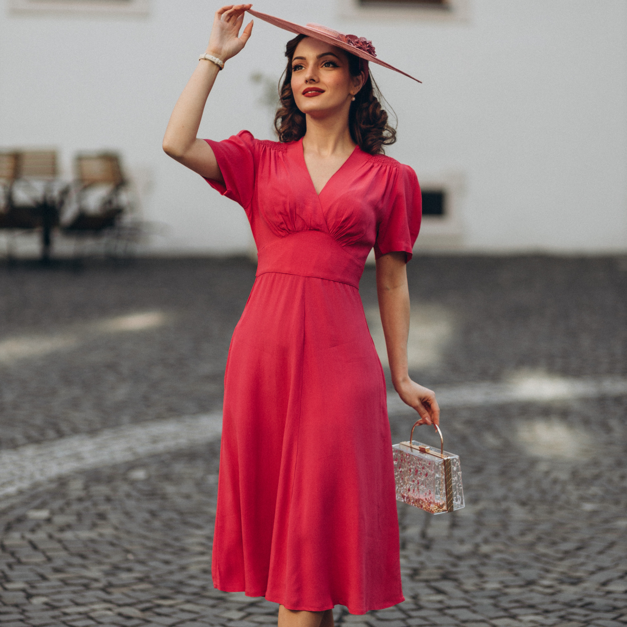 Model wears a 1940s-style raspberry pink dress and matching vintage accessories. 
