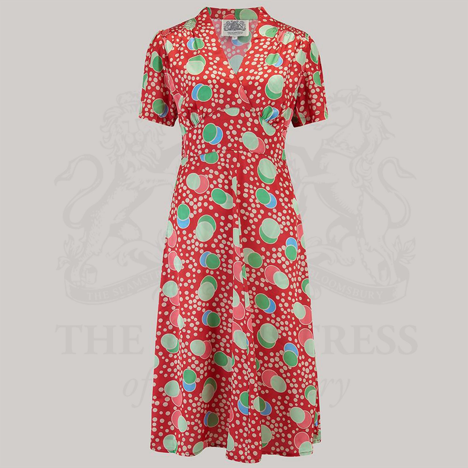 A 1940s-style swing dance dress with a v-neck, and in atomic inspired red pattern.