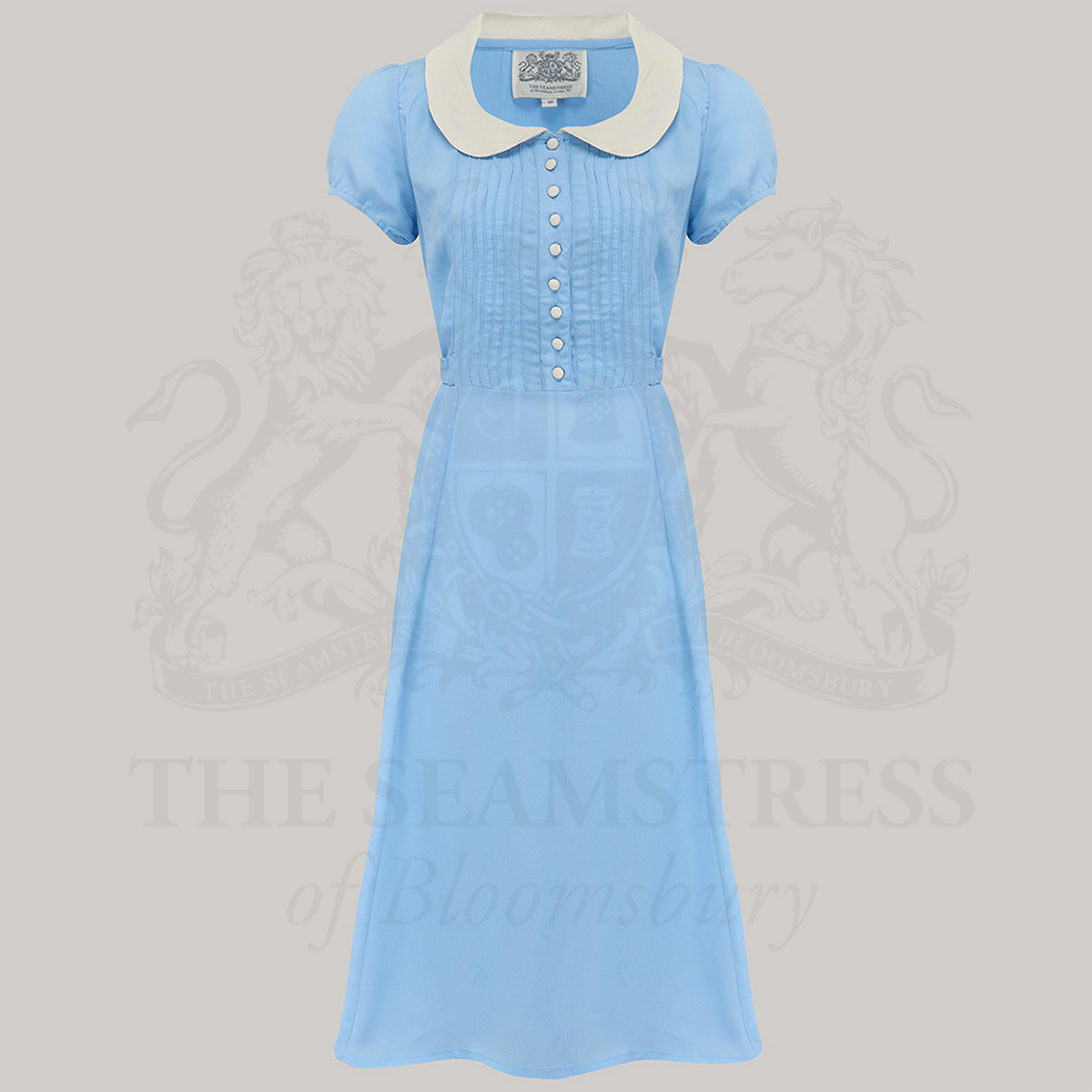 1940s-inspired shirtdress in pale blue with contrasting cream collar and bodice buttons.