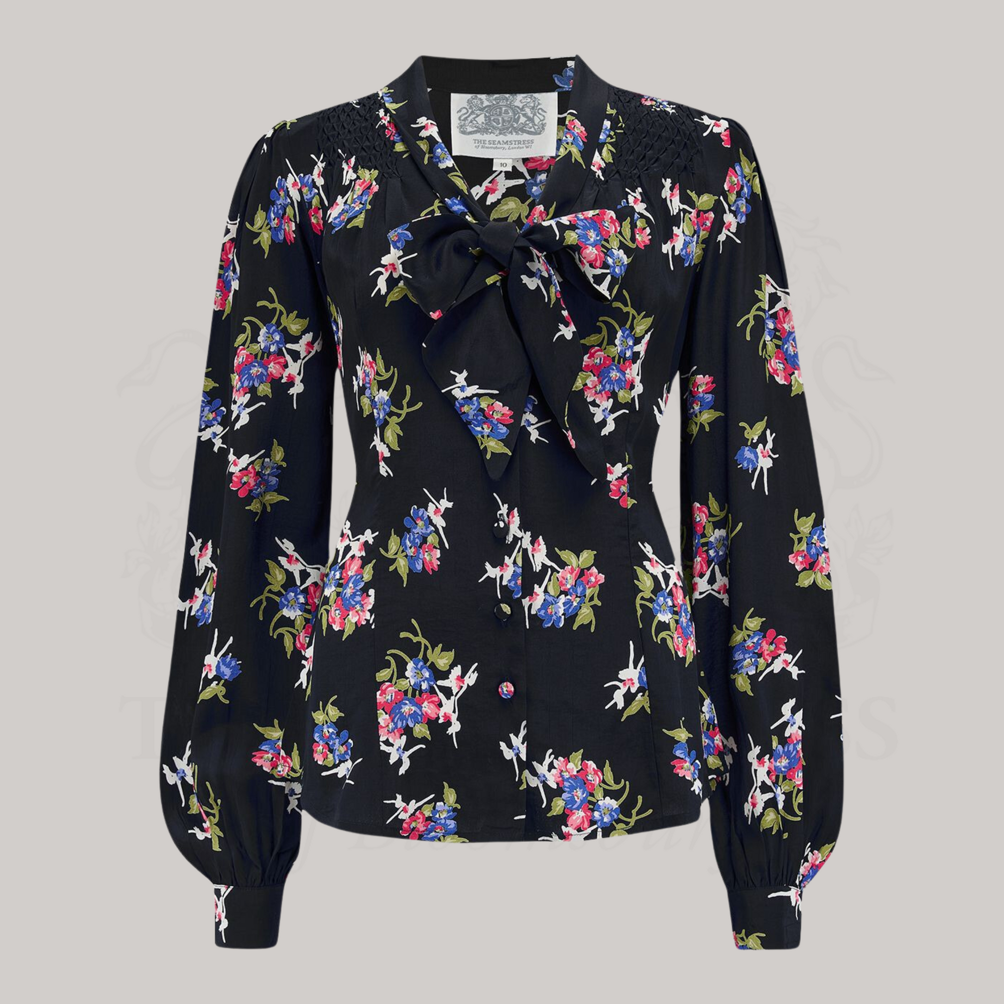 A black floral pussy bow blouse with long bishop sleeves and button fastenings.