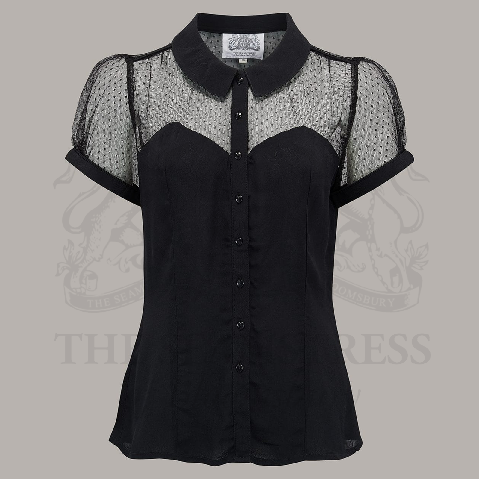 A black, short-sleeved blouse with a pointed collar, spotted netting, and heart-shaped buttons.