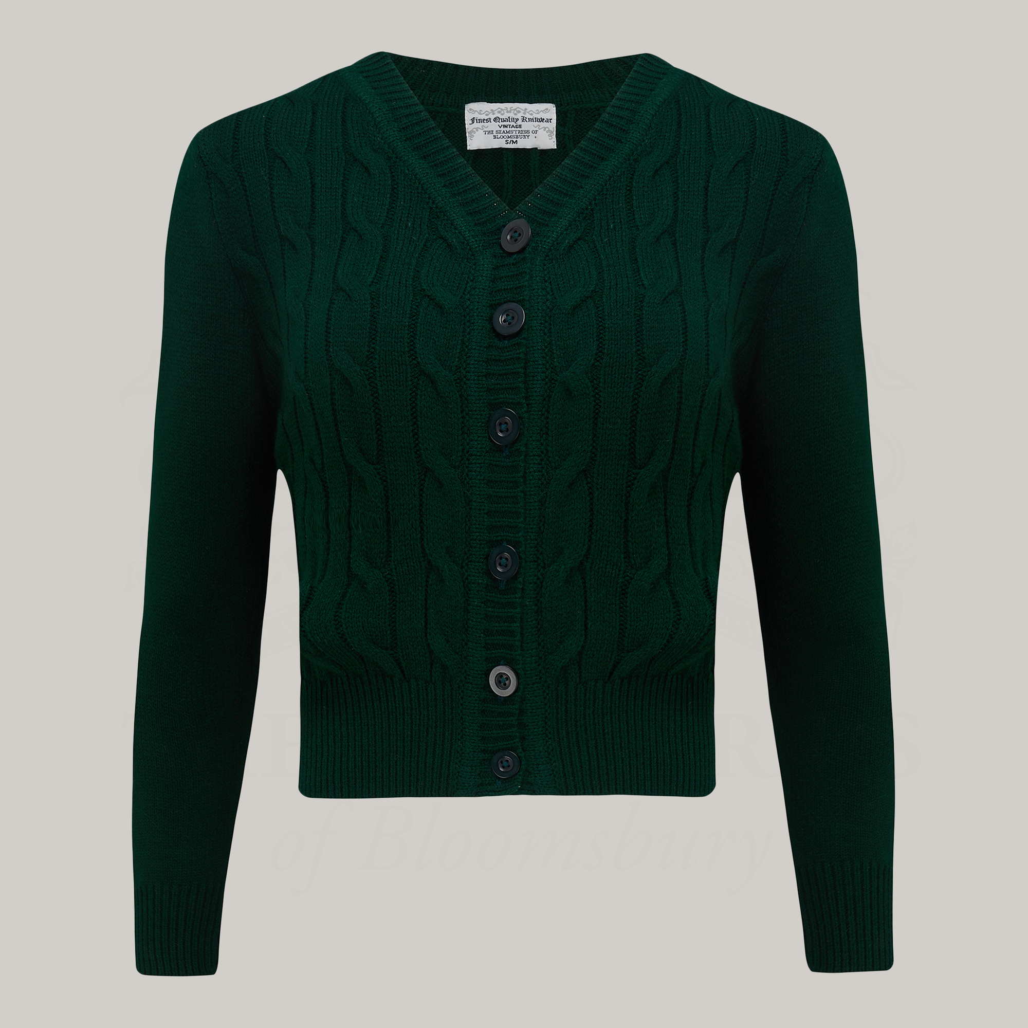 A 1940s style cable knitted cardigan in dark green. Matching green buttons feature down the front of the cardigan.