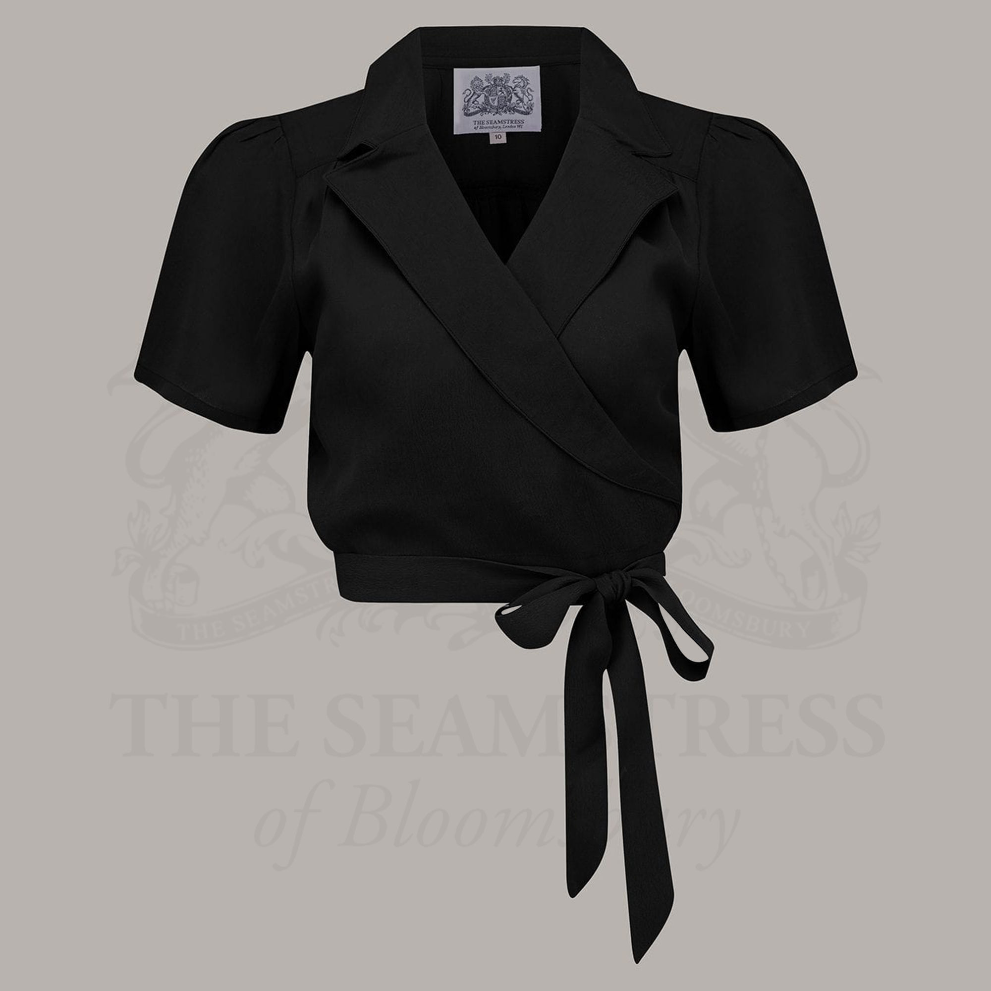A black wrap blouse with short sleeves and a revere collar
