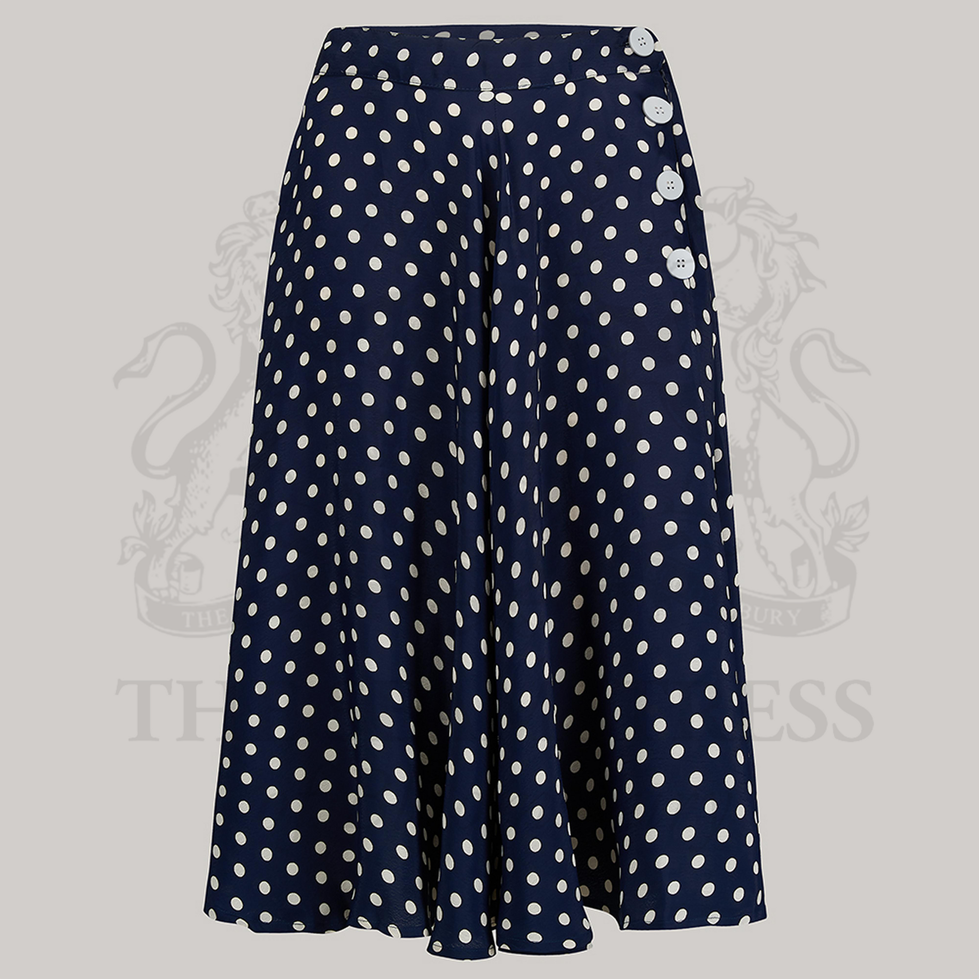 A navy polka-dot skirt with a full-circle silhouette. The skirt has decorative buttons on the left side and a side seam zip closure.