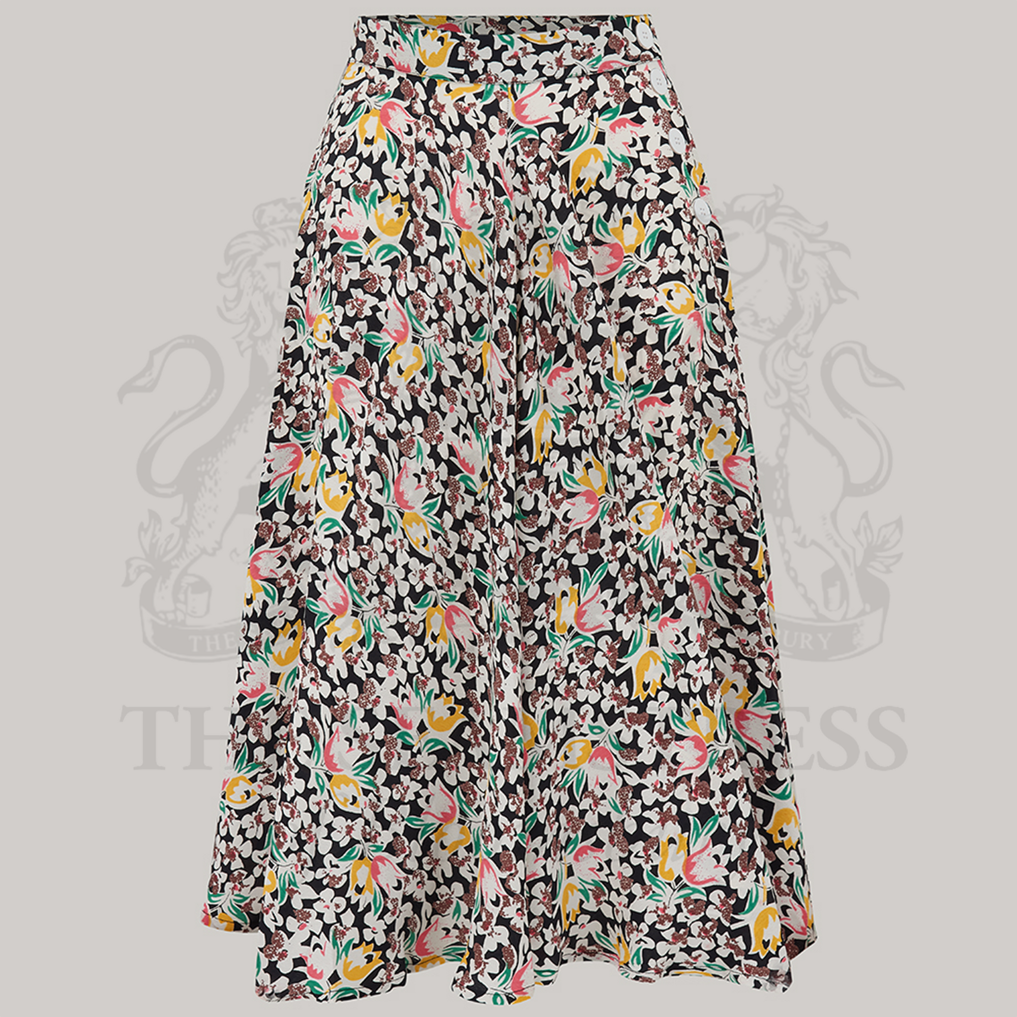 A floral print Isabelle skirt with a full-circle silhouette, featuring decorative buttons on the left side and a side seam zip closure.