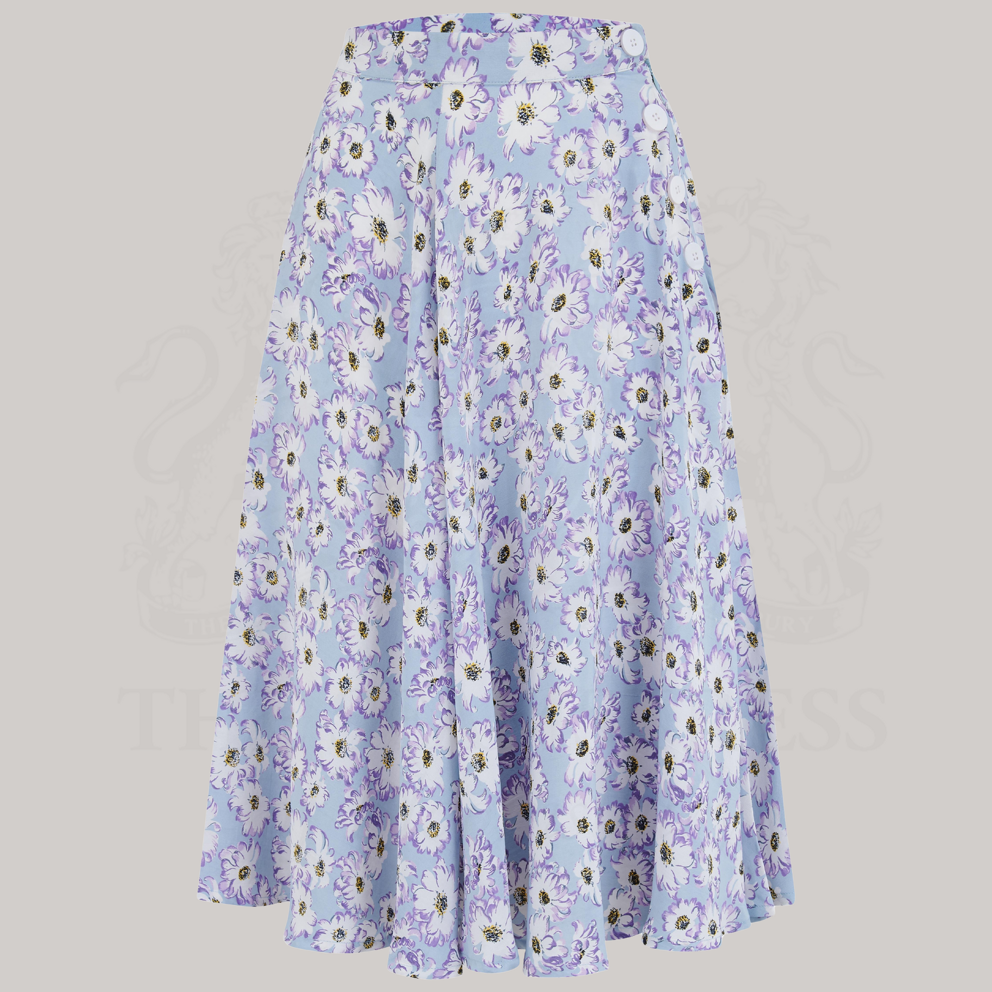 A blue and white floral skirt with a full-circle silhouette, wearing a white blouse and vintage accessories.