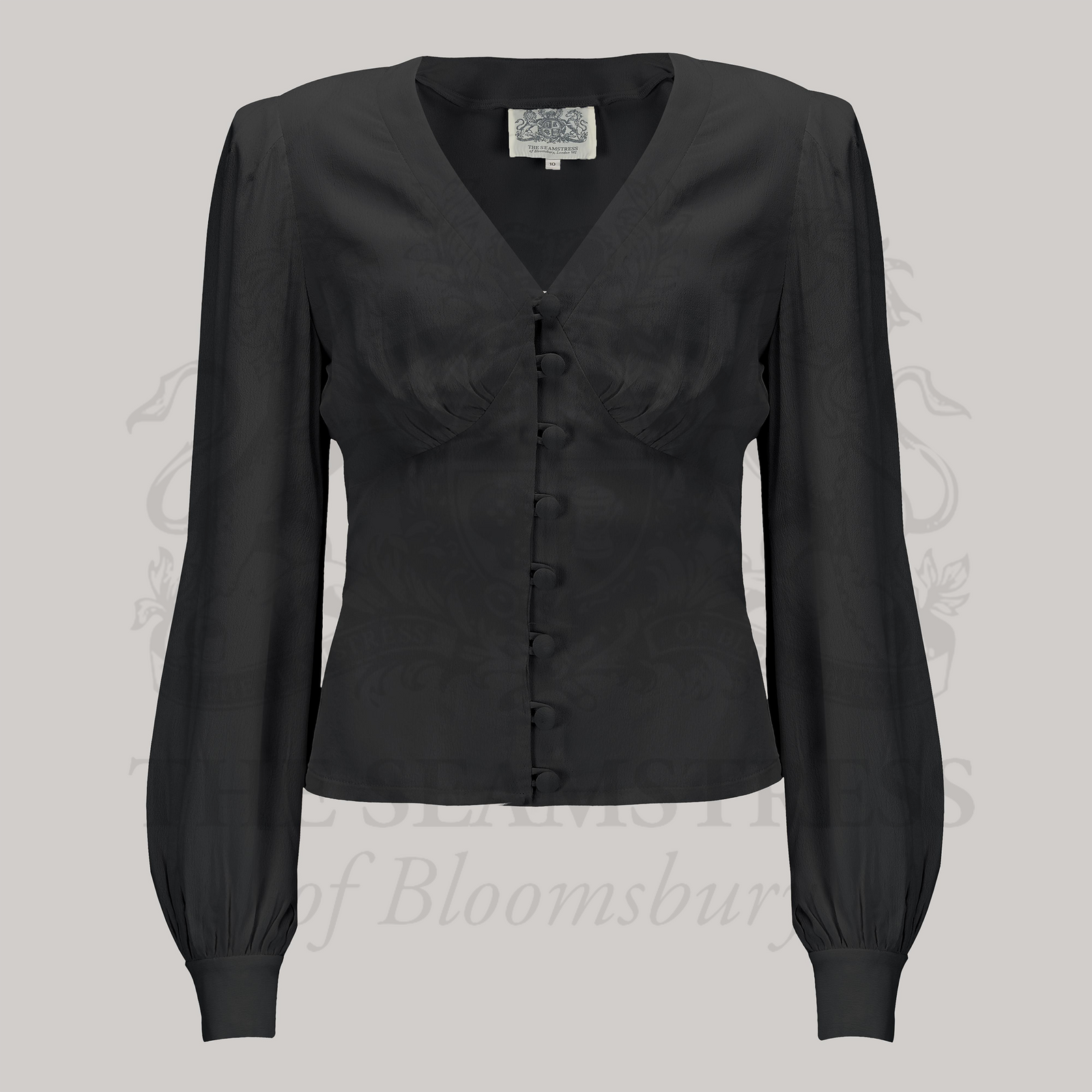 A black, long-sleeved Jay blouse with a V-neckline and button-up front, made of crepe de chine fabric.