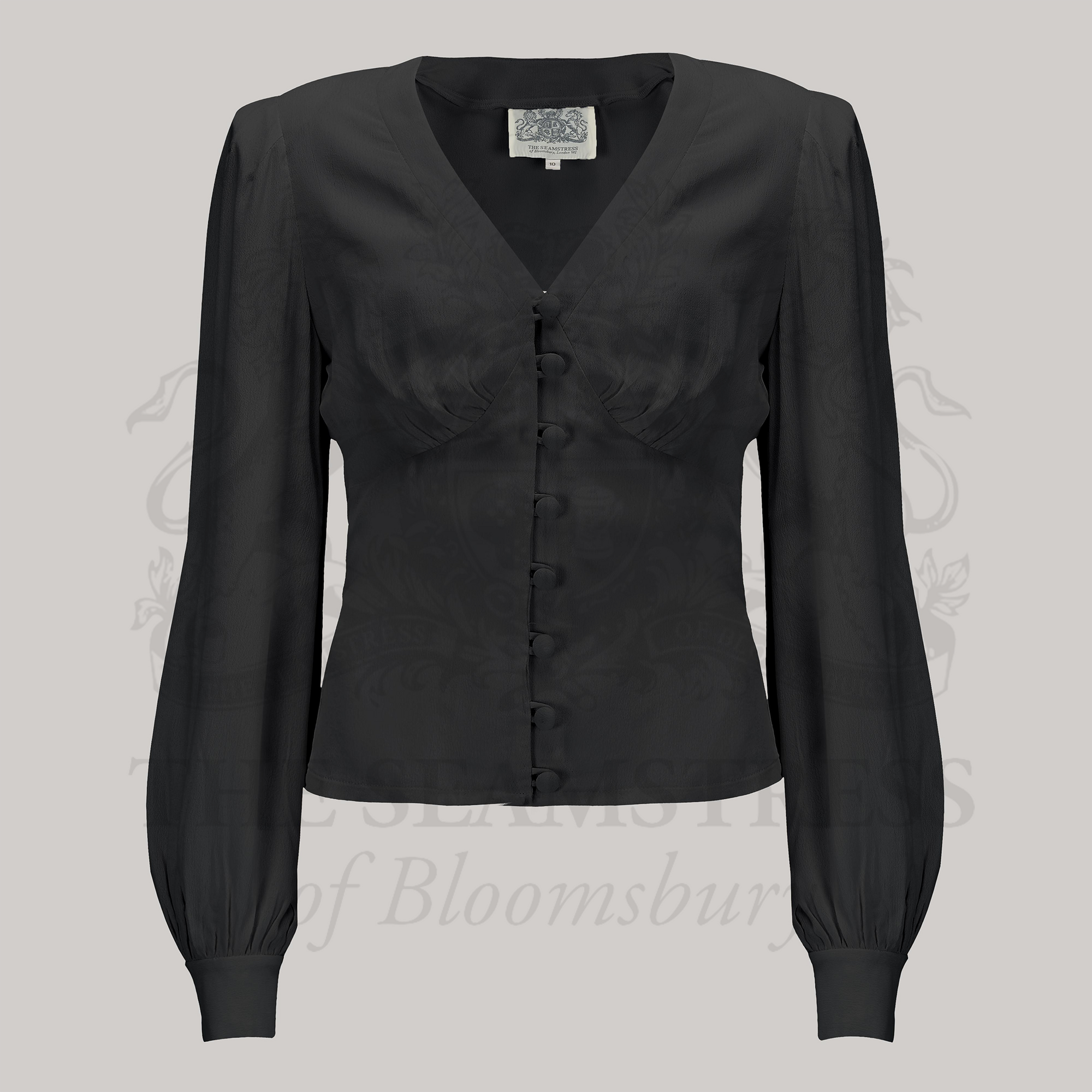 A black, long-sleeved Jay blouse with a V-neckline and button-up front, made of crepe de chine fabric.