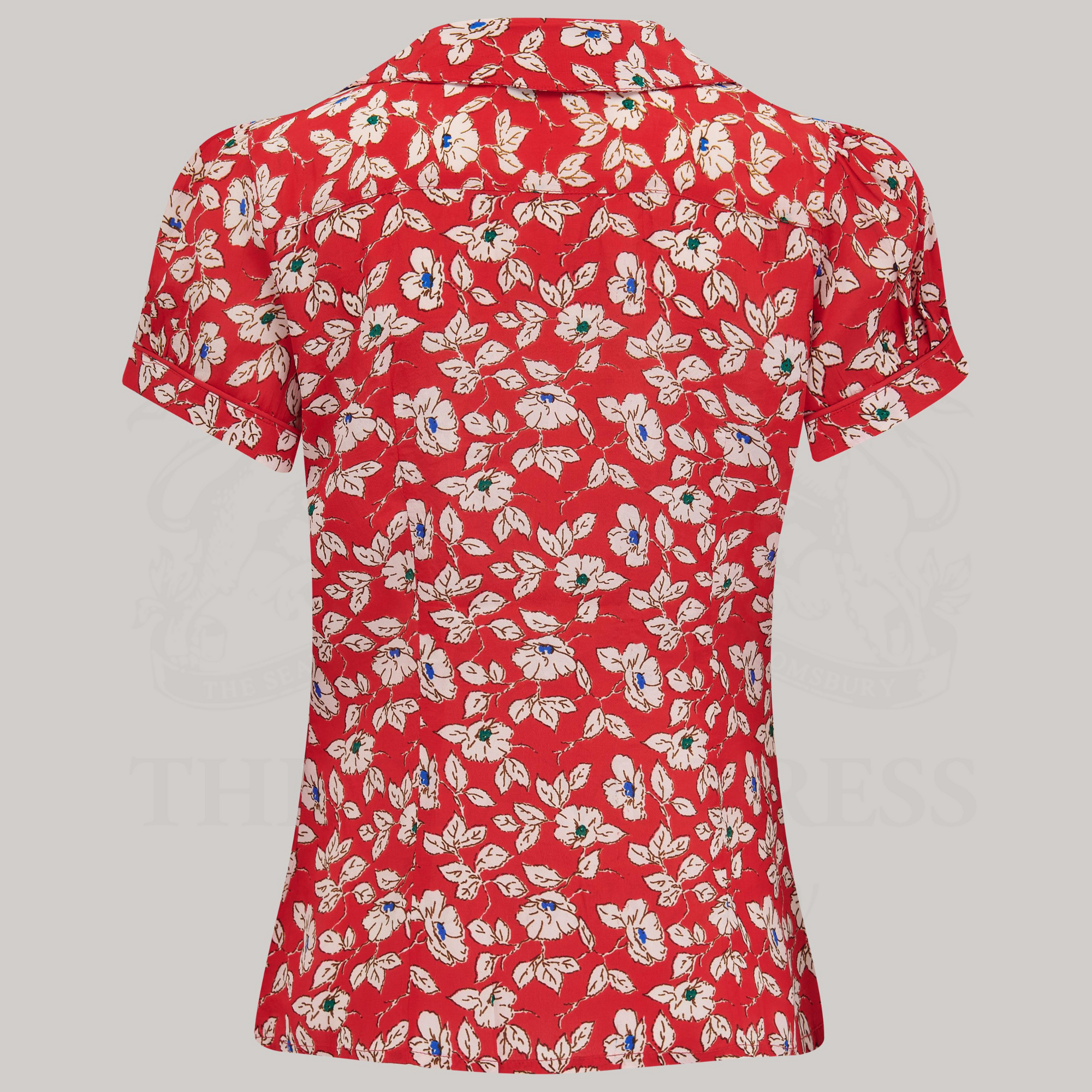 A short-sleeved red blouse with a pansy print, featuring a Peter Pan collar and puff sleeves.