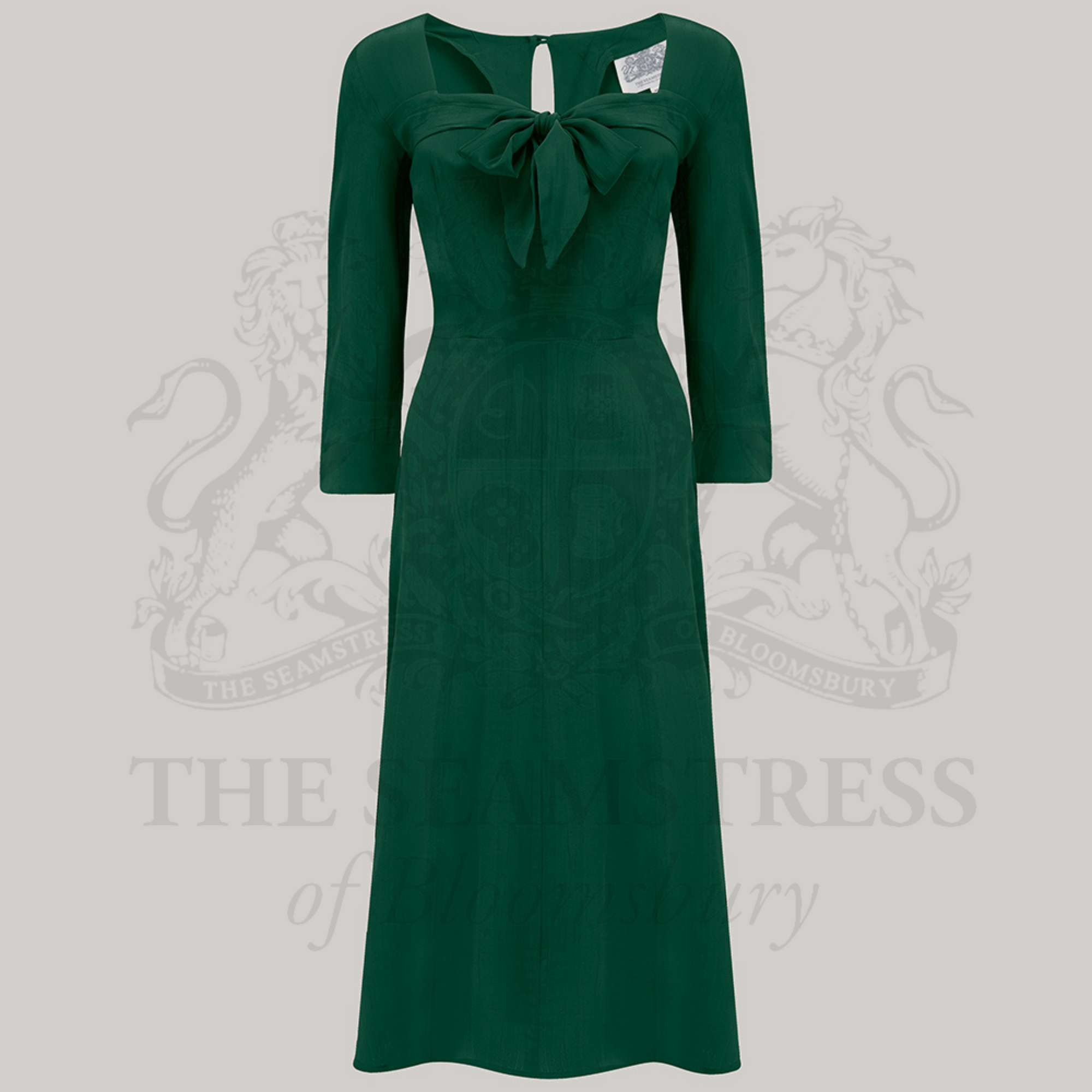 A green dress with a sweetheart neckline and a centre front pussy bow
