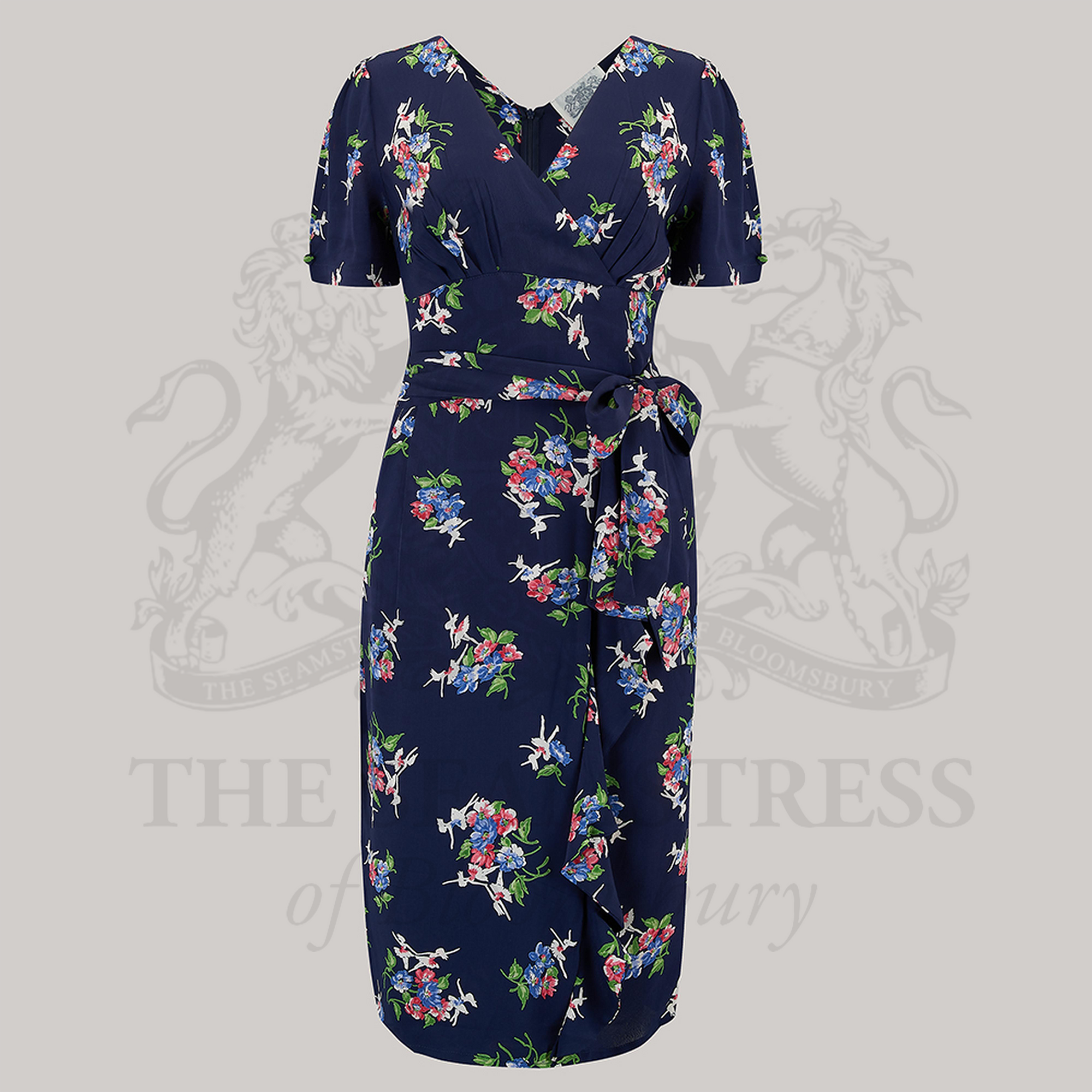 A navy floral dress with puff sleeves, a deep V-neck, and a waist tie-belt. 