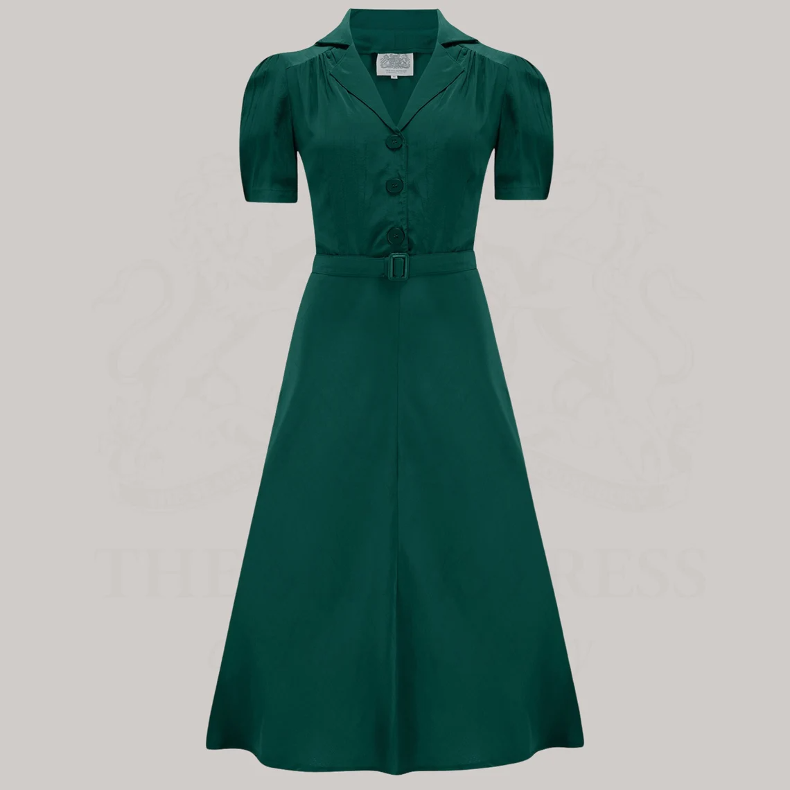 A green, shirtwaist-style dress with a button-down bodice and a matching waist belt. 