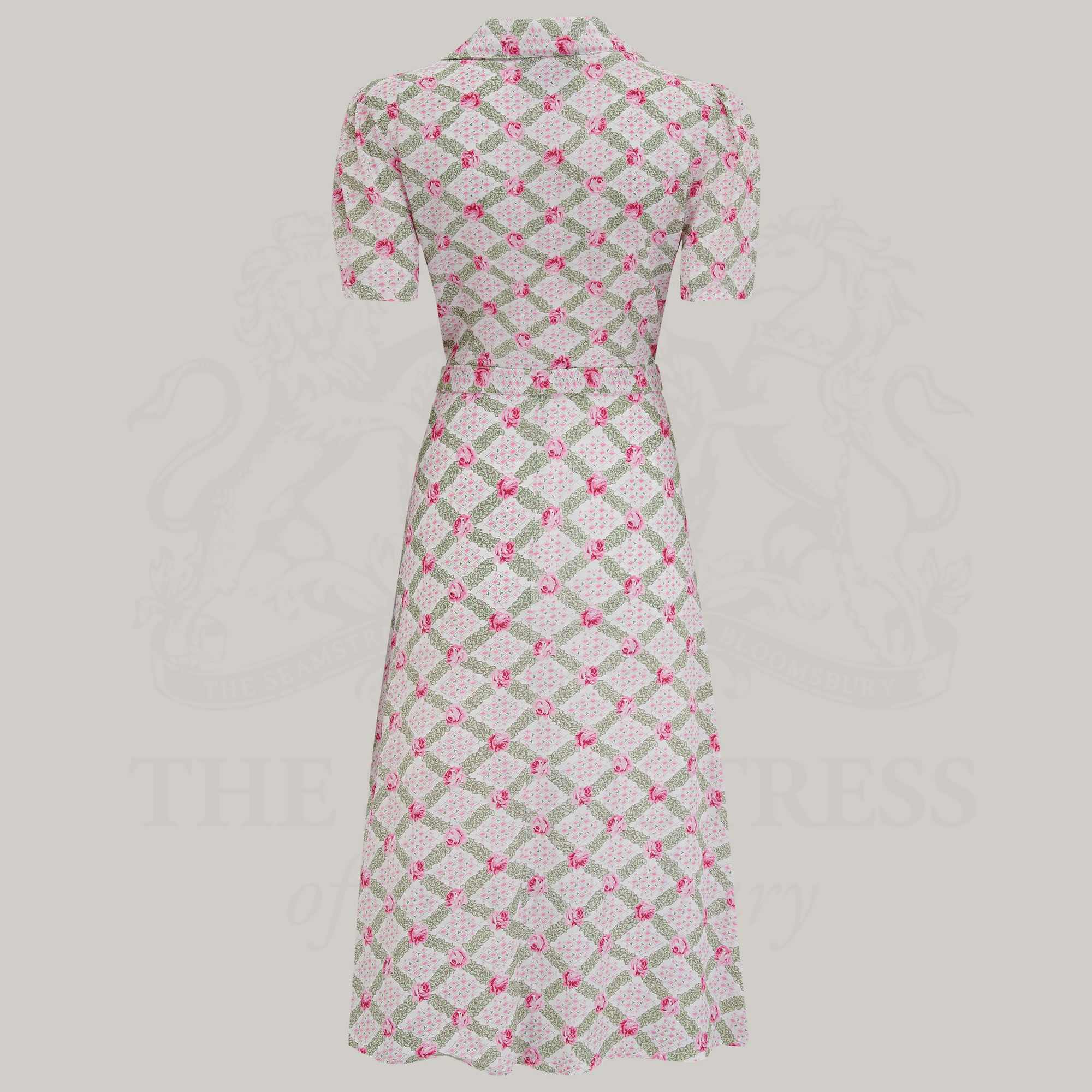 A rose kiss print shirtwaister dress with a tailored silhouette, button-down bodice, and side-seam pockets. 