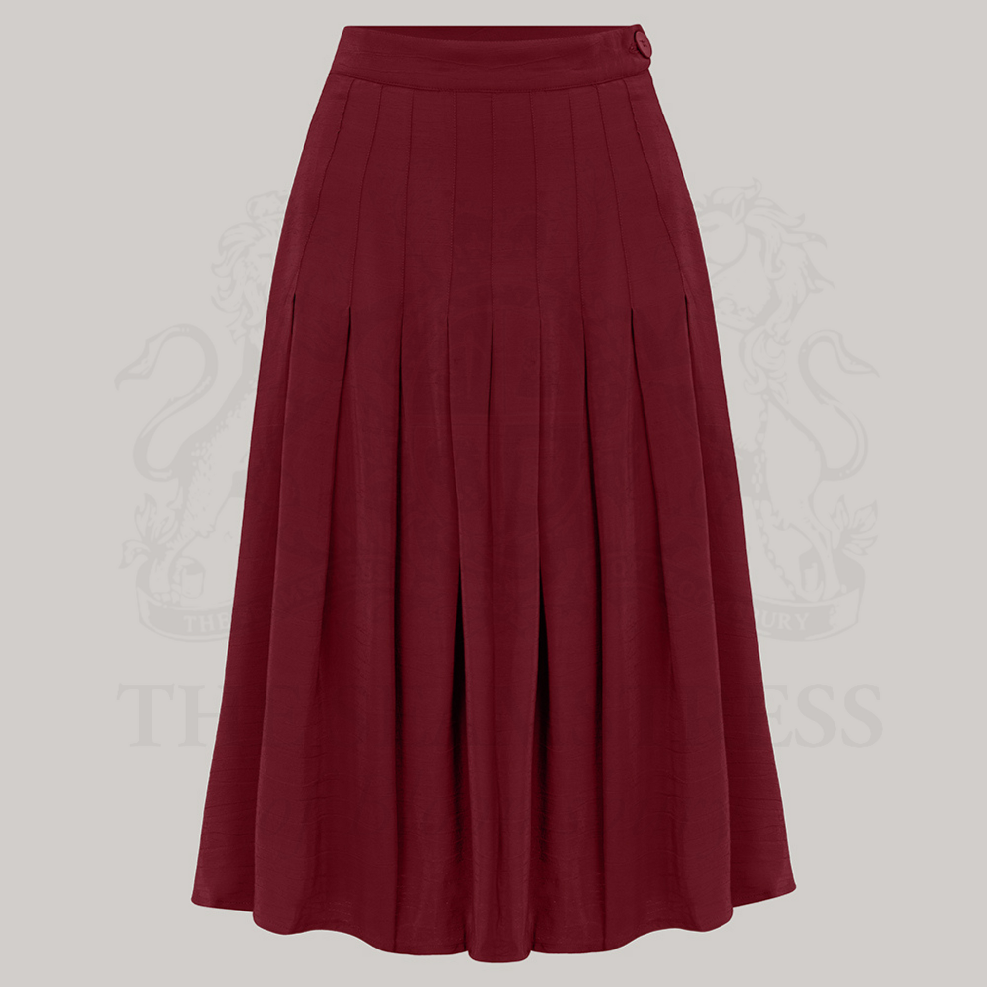 A pleated skirt in Windsor Wine color with pin-stitched inverted pleats and a bakelite-style button on the waist.
