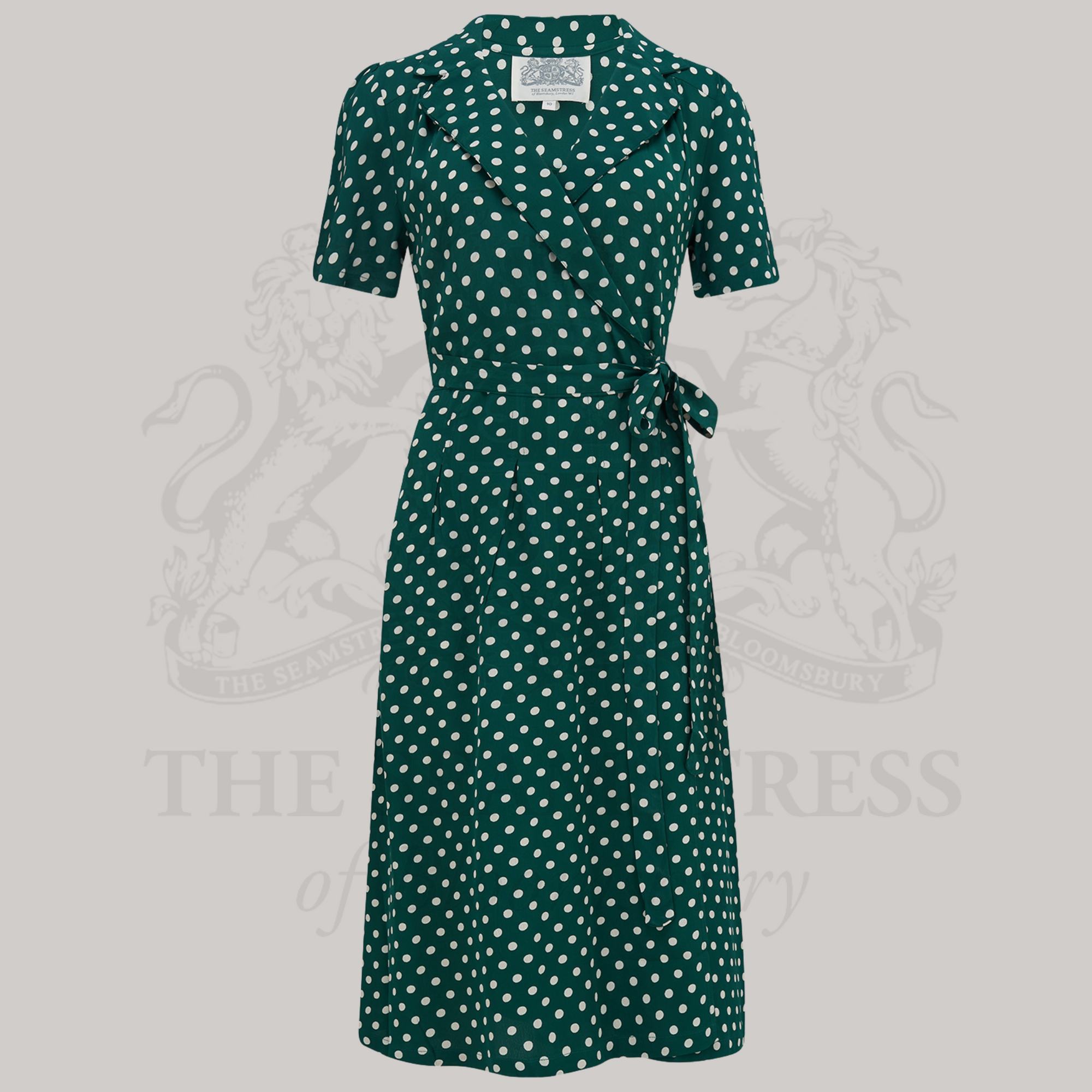 A green polka-dot wrap dress with revere collar and short sleeves