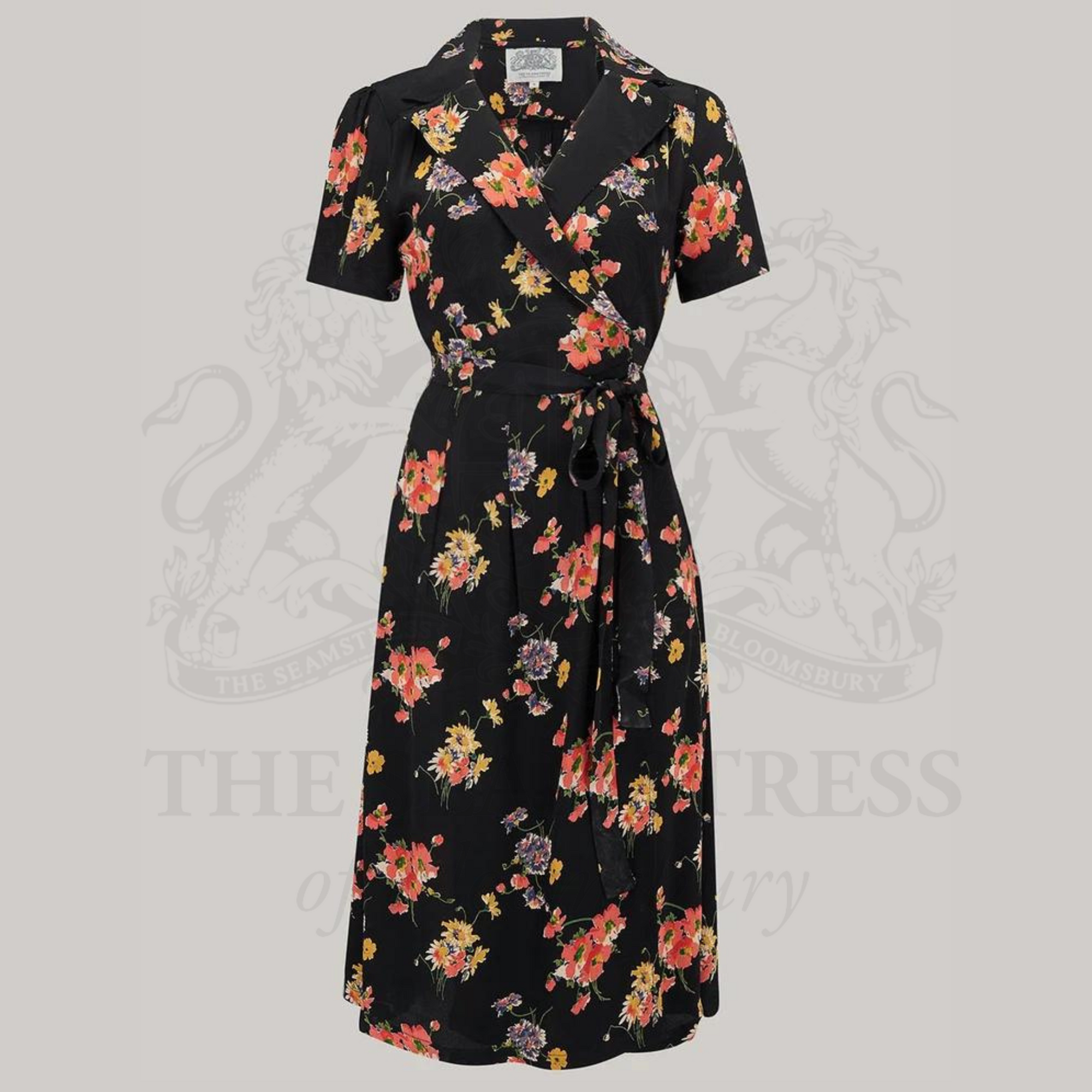 A black mayflower wrap dress with a floral pattern, featuring a v-neck and short sleeves