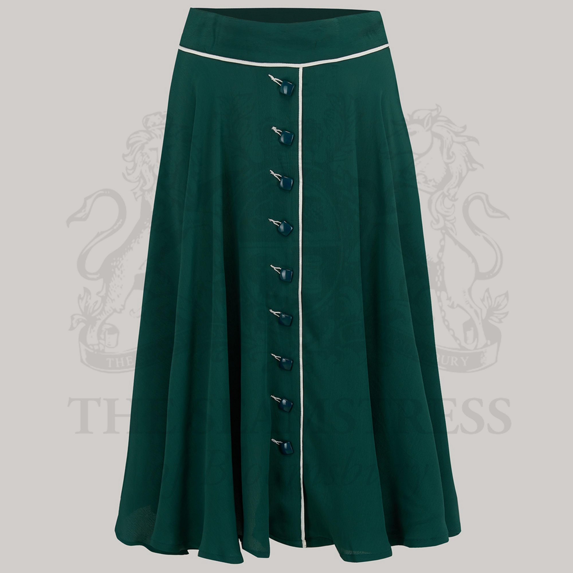 A green full circle skirt with diagonal cream contrasting buttonholes and jet-style buttons, made of crepe de chine fabric.