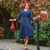 woman wearing 1940s style navy shirtwaist dress, with matching vintage accessories