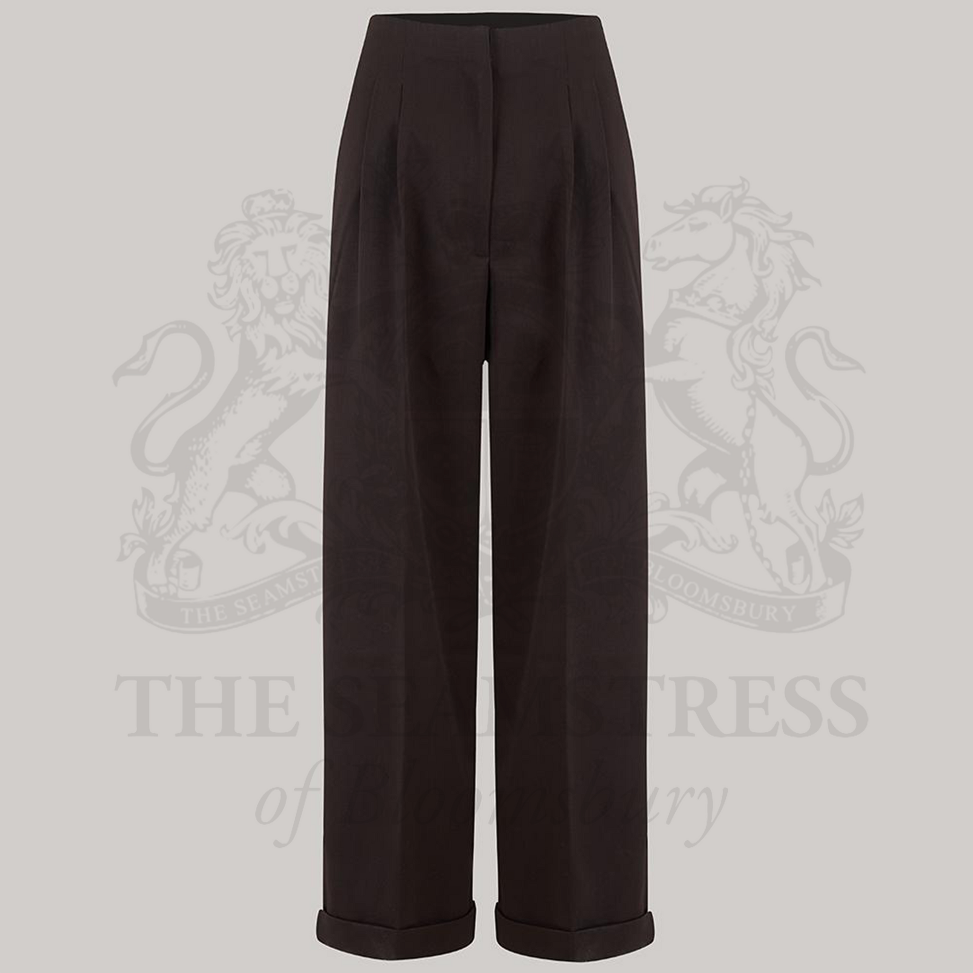 High-waisted tailored brown trousers on a grey background.