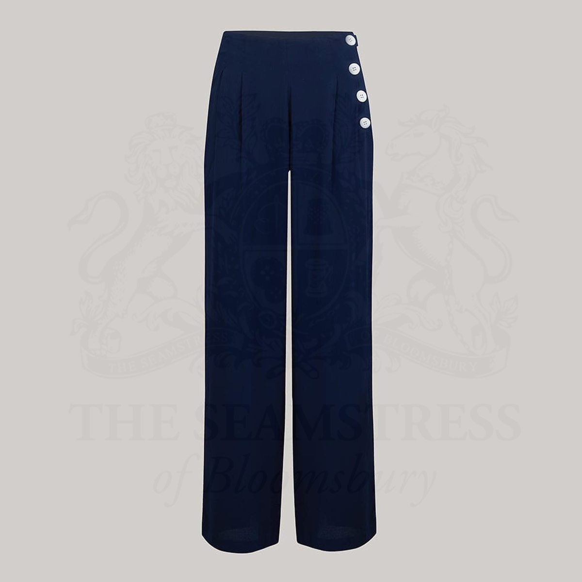 Wide-leg 1940s women’s trousers in navy blue. Four decorative buttons are down the left from the waist with a hidden zip in the side seam. 