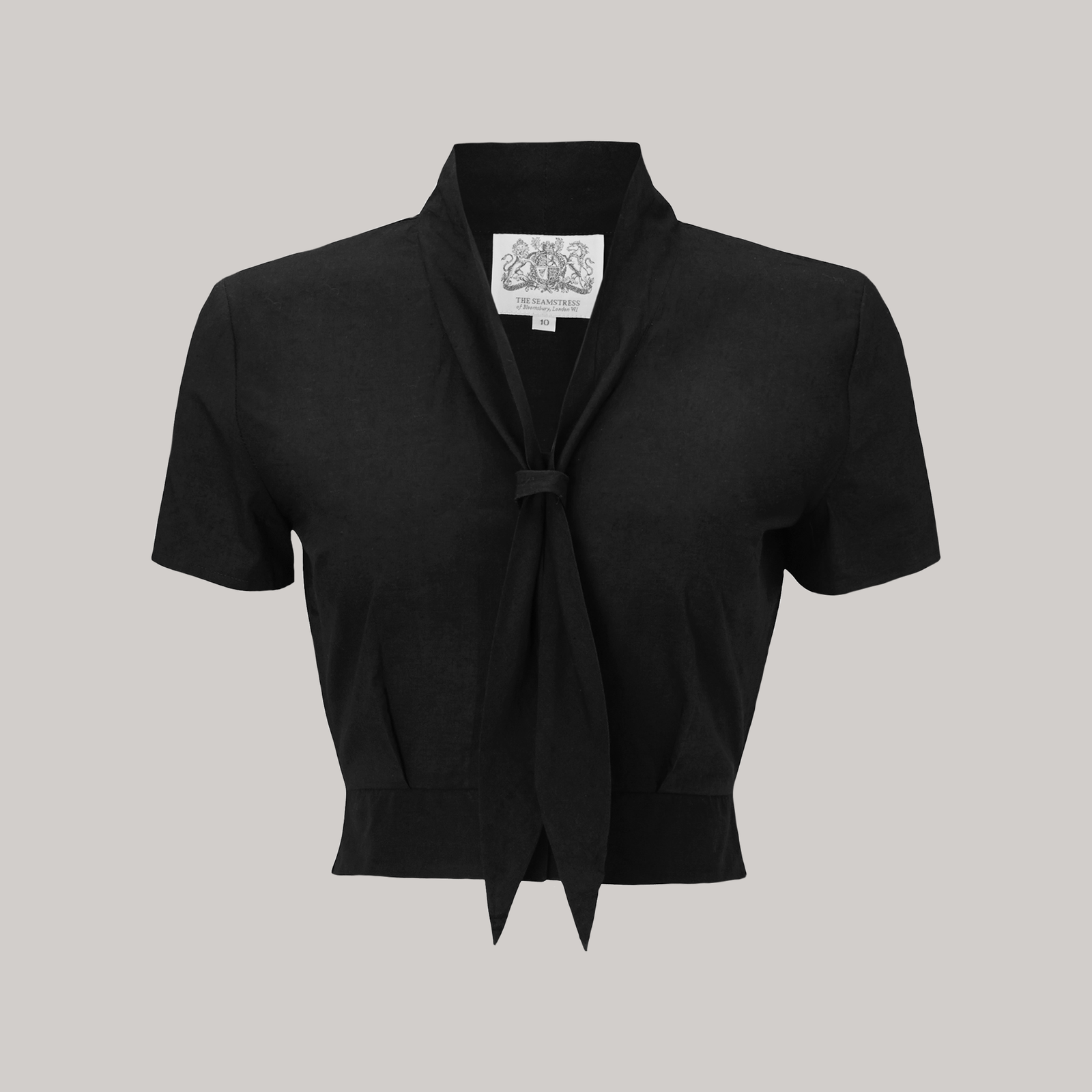 A 1940s sailor-style blouse in black. Featuring a roll-style sailor collar. Small buttons run down the front of the blouse for fastening but are hidden by the long collar.
