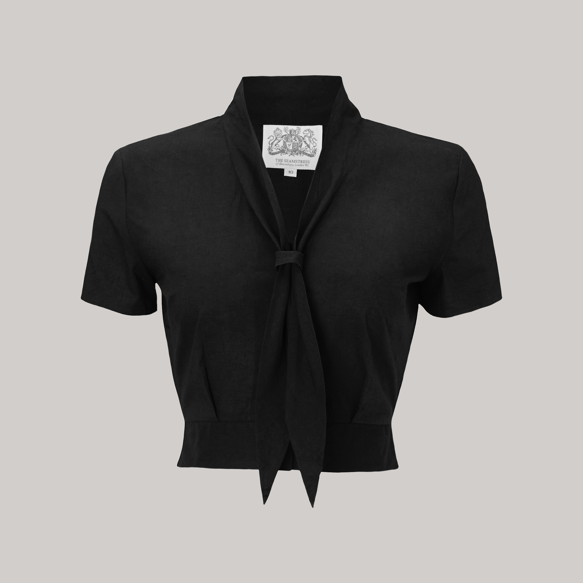 A 1940s sailor style blouse with short sleeves in black. Featuring a roll style collar to give the iconic sailor look. Small buttons run down the front of the blouse for fastening but are hidden by the long collar.