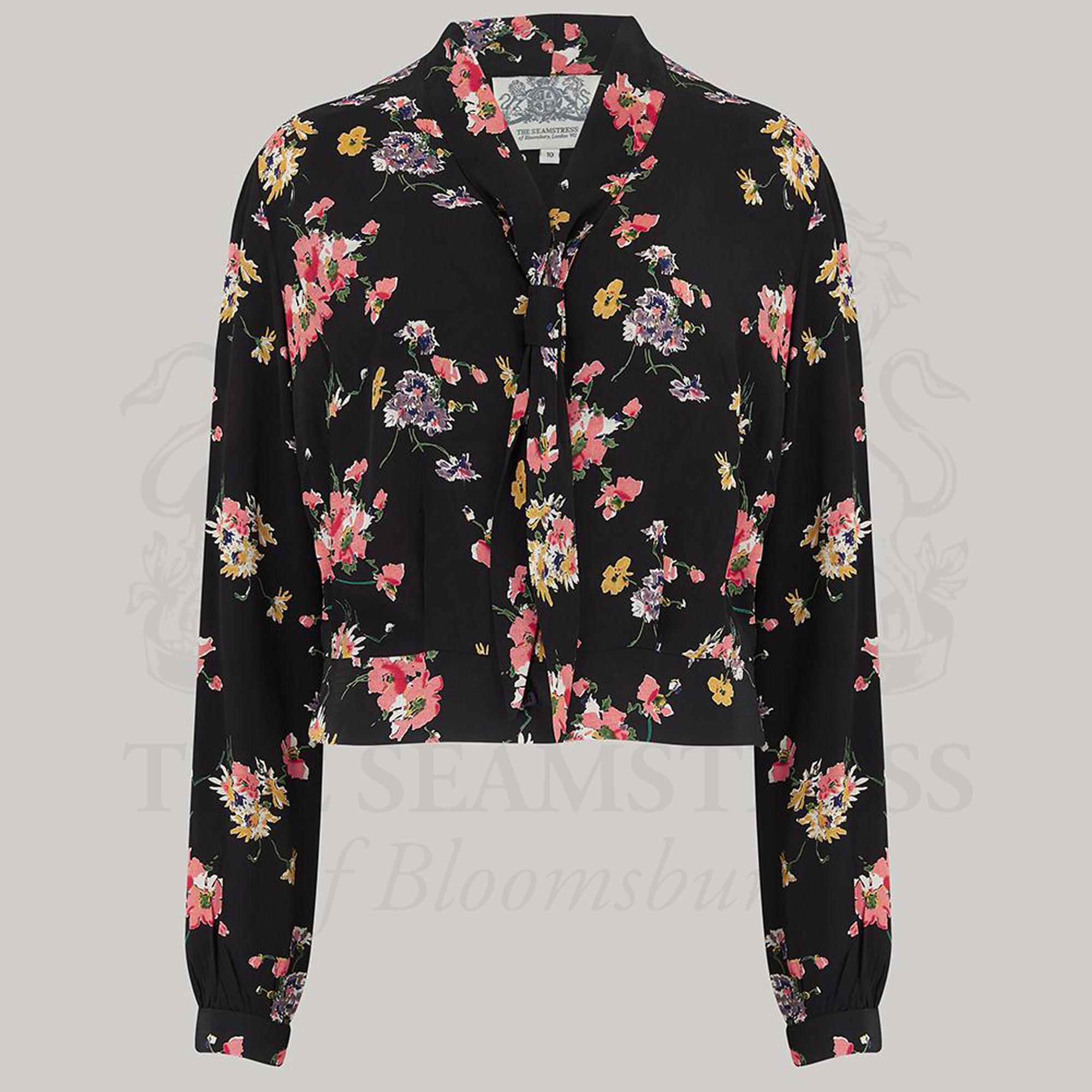 A 1940s sailor style blouse with a floral patterns. Featuring a roll style sailor collar. Small buttons run down the front of the blouse for fastening but are hidden by the long collar.