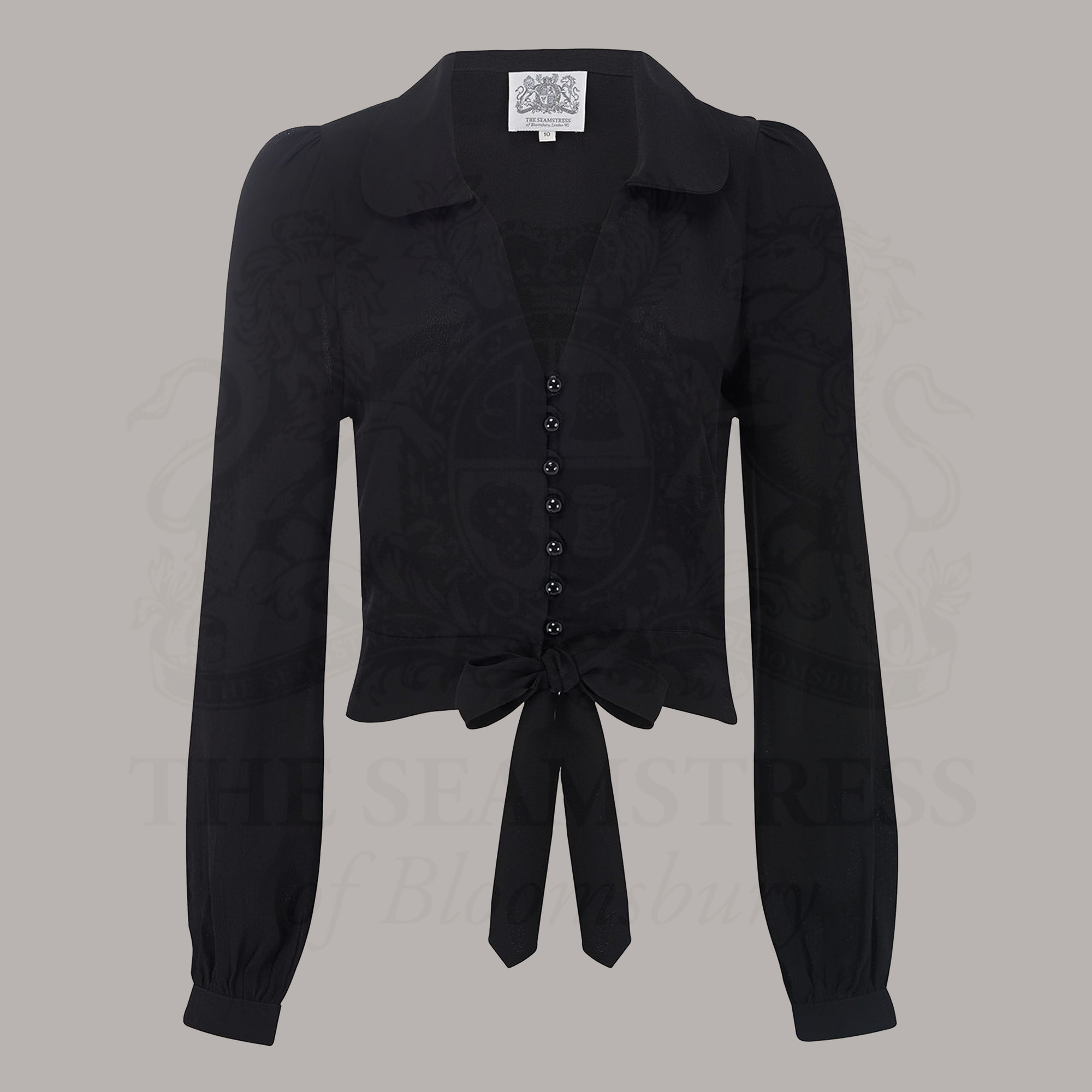 A 1940s-style long-sleeve blouse in black. The blouse has a v-neck, button fastenings on the front, and a waist tie.
