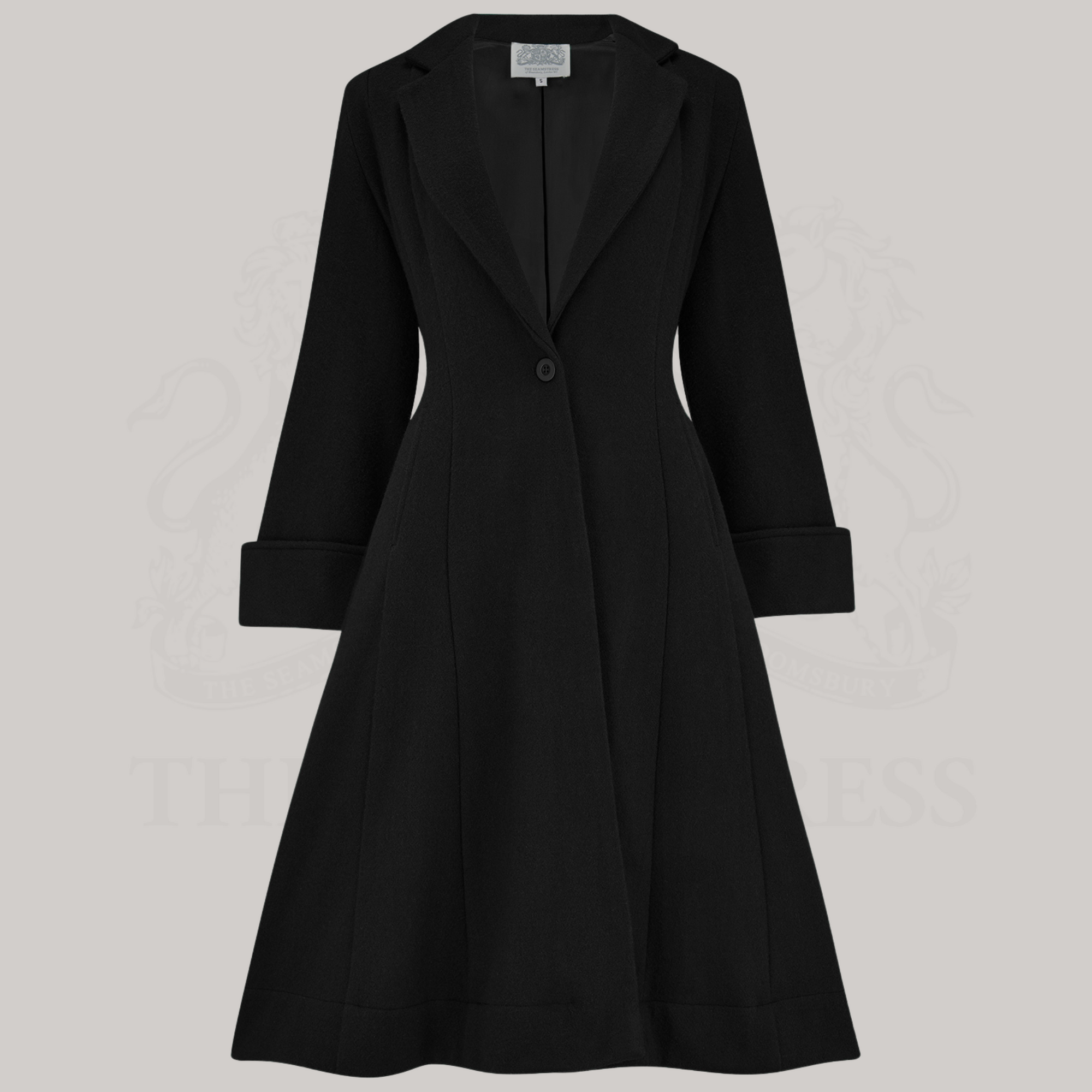 A black fitted coat with side pockets and button fastening at the waist