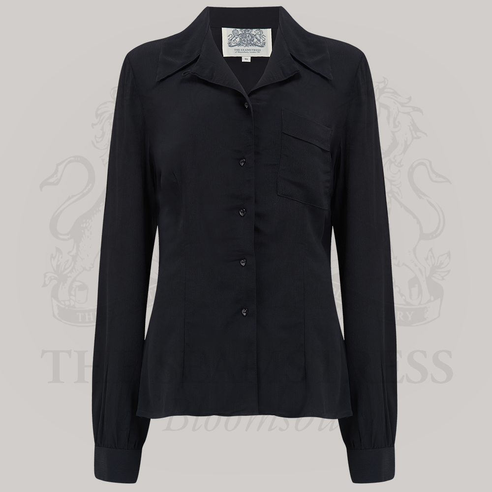 A classic black blouse with a convertible collar, long sleeves, and button fastening, made from Crepe de Chine fabric.