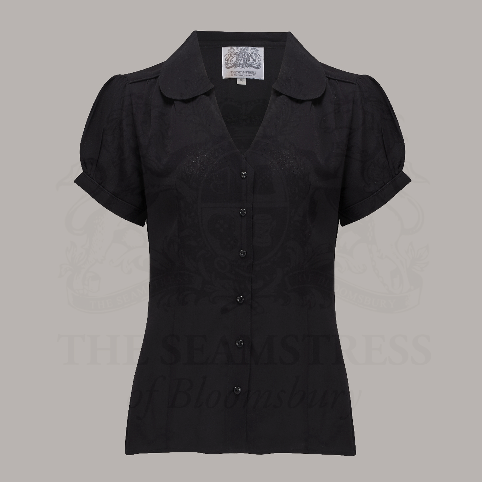 A vintage-style black blouse with a Peter Pan-style collar and puff sleeves, buttoned V-front fastening, and short sleeves.