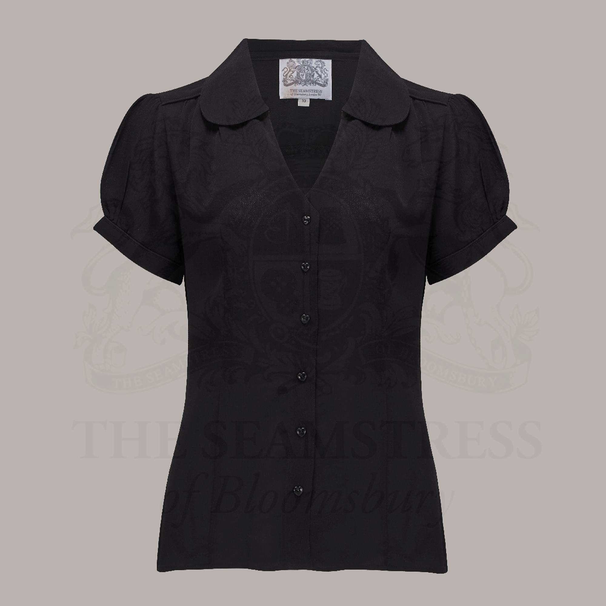 A vintage-style black blouse with a Peter Pan-style collar and puff sleeves, buttoned V-front fastening, and short sleeves.
