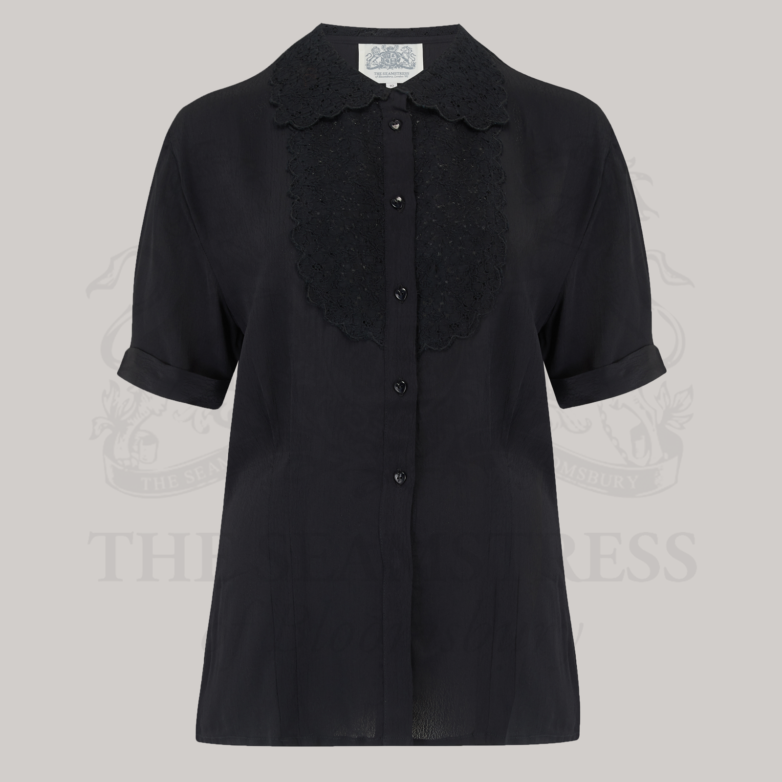 A classic black blouse with a lace collar and heart-shaped buttons