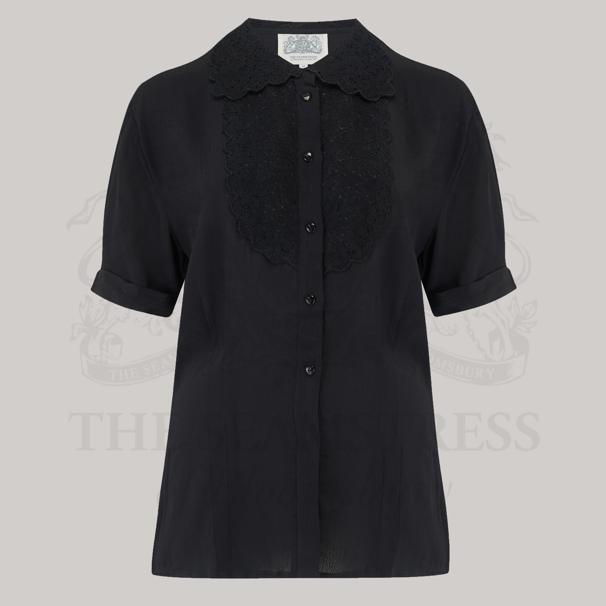 A classic black blouse with a lace collar and heart-shaped buttons