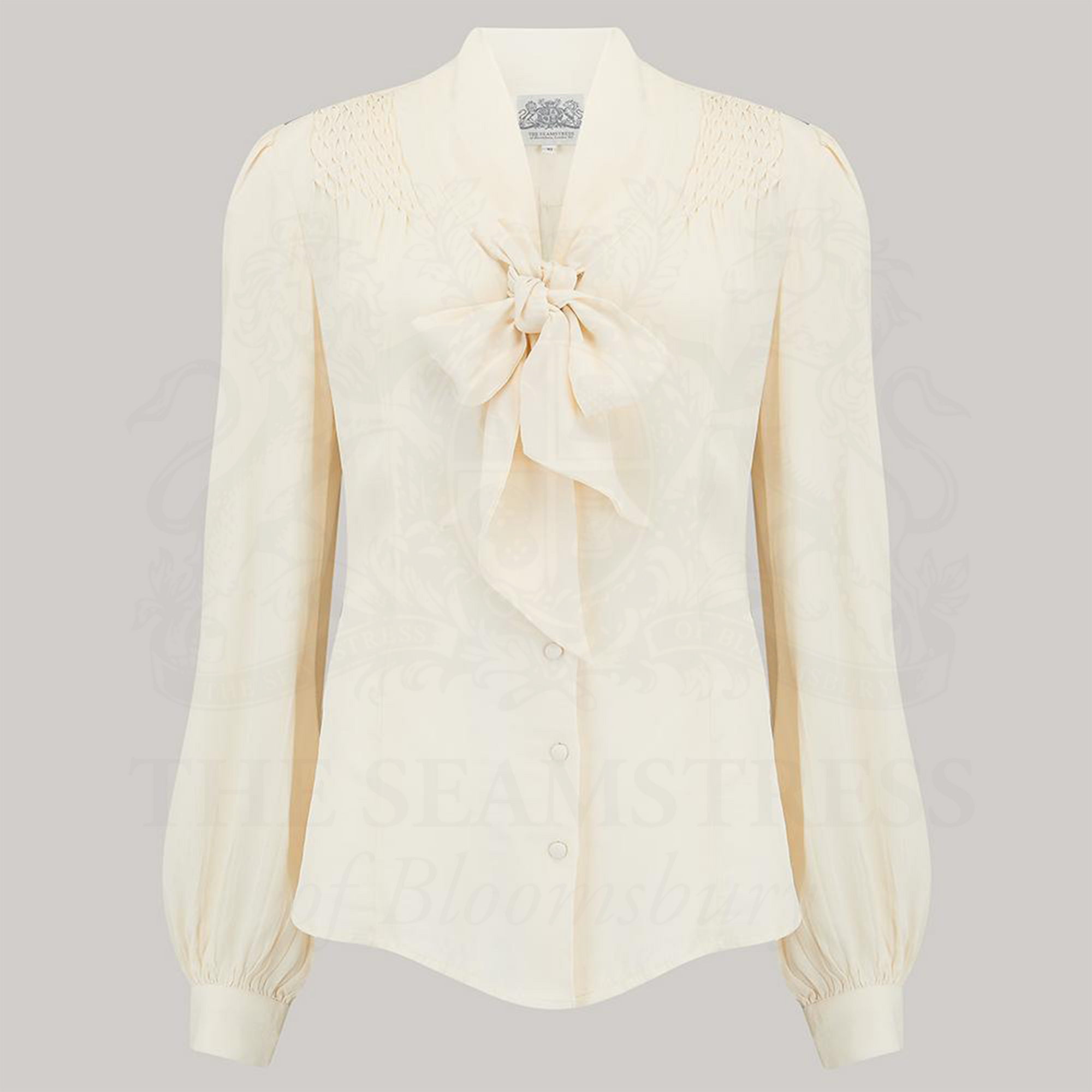 A Pussy Bow Blouse in Cream, with long bishop sleeves and a pussy-bow neckline.