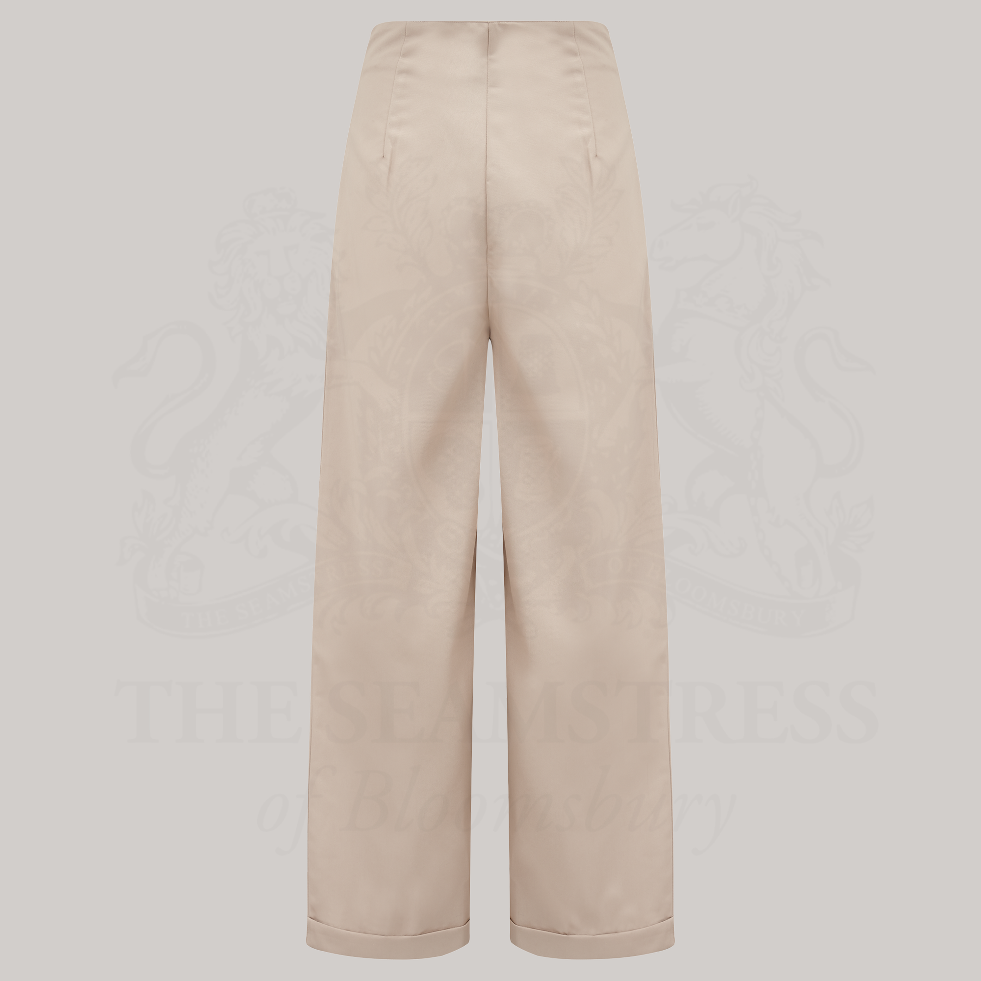 High-waisted tailored stone trousers on a grey background.