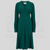 A 1940s style long sleeve dress in dark green. Featuring gauged-in top yoke detailing on the shoulders and sleeves that puff out fully at the cuff. 4 small buttons down the front of the dress, and a tie-waist belt. 