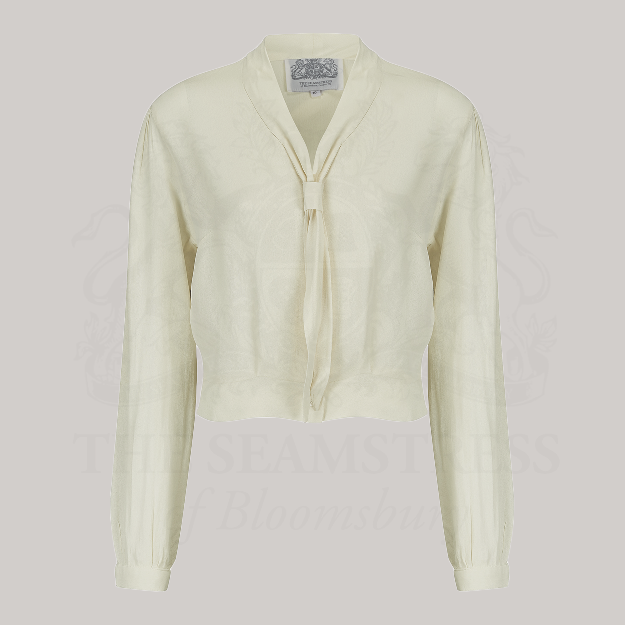 A 1940s sailor style blouse in cream. Featuring a roll style sailor collar. Small buttons run down the front of the blouse for fastening but are hidden by the long collar.