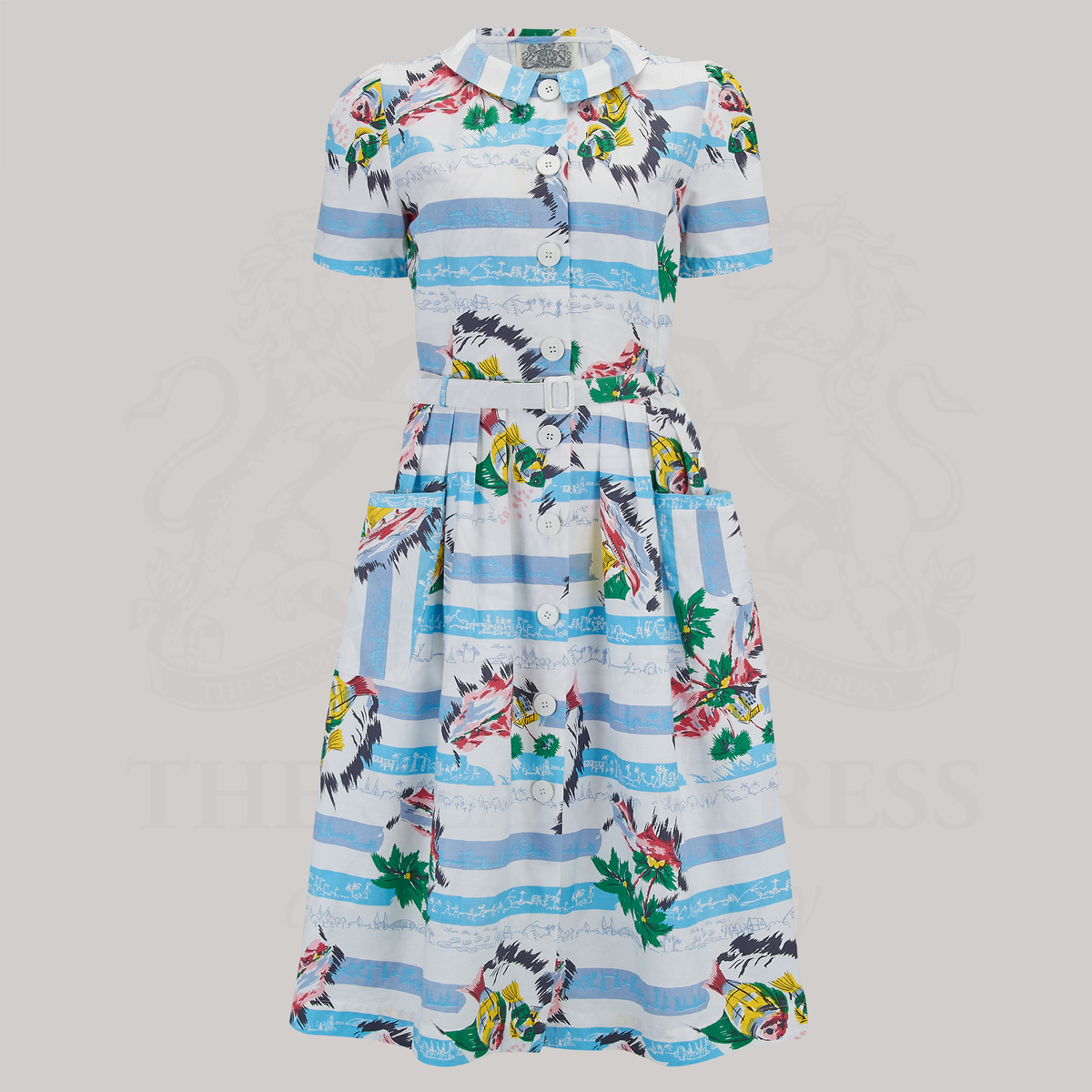 A 1940s-style short sleeve dress in a vintage seaside-inspired print. Made from cotton with two front patch pockets, nine buttons down the front of the dress and a matching waist belt.